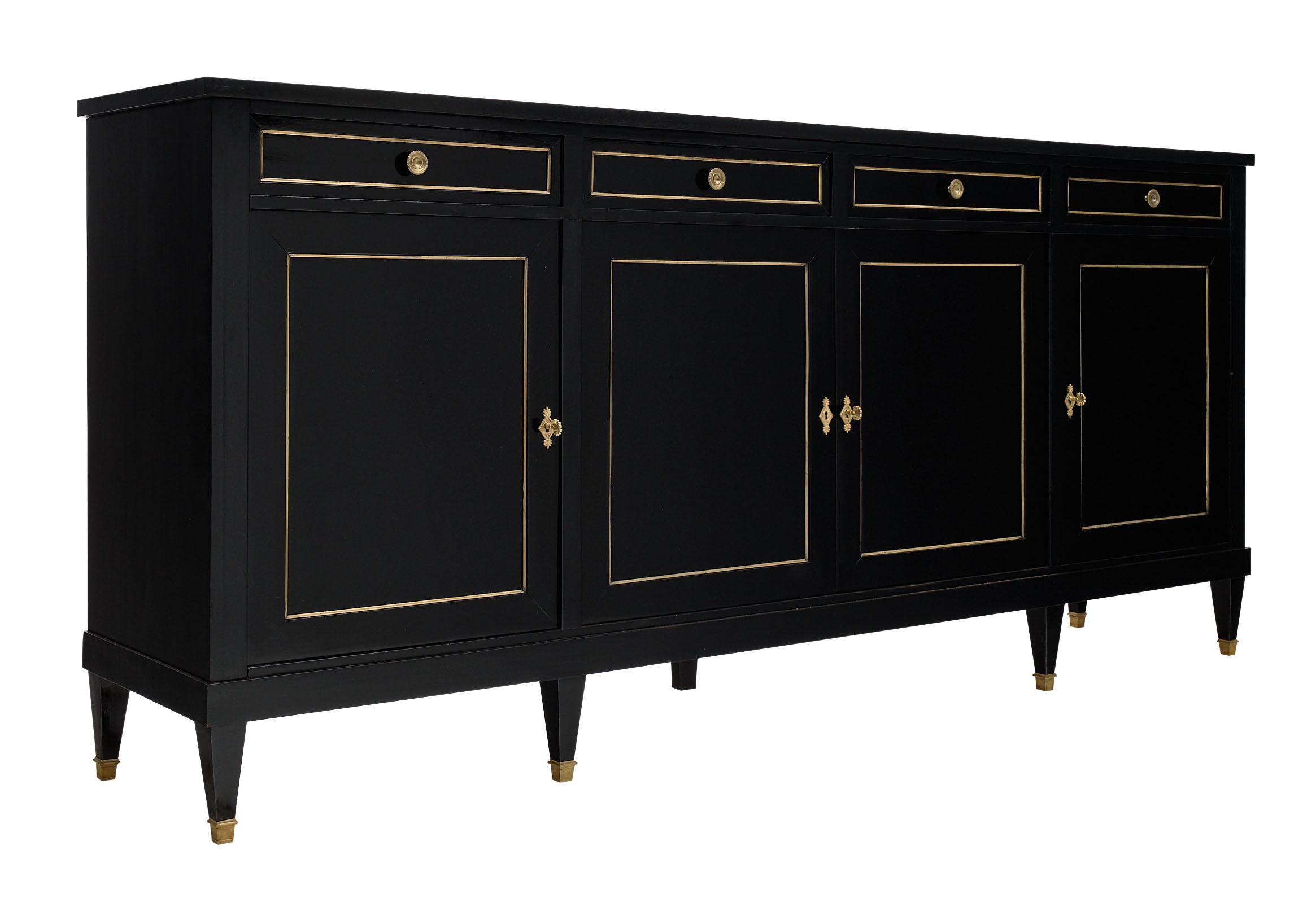 Directoire style ebonized buffet from France made of mahogany and finished in a museum quality lustrous ebony French polish. There are four dovetailed drawers above four doors with the original working locks and keys opening to adjustable shelves.