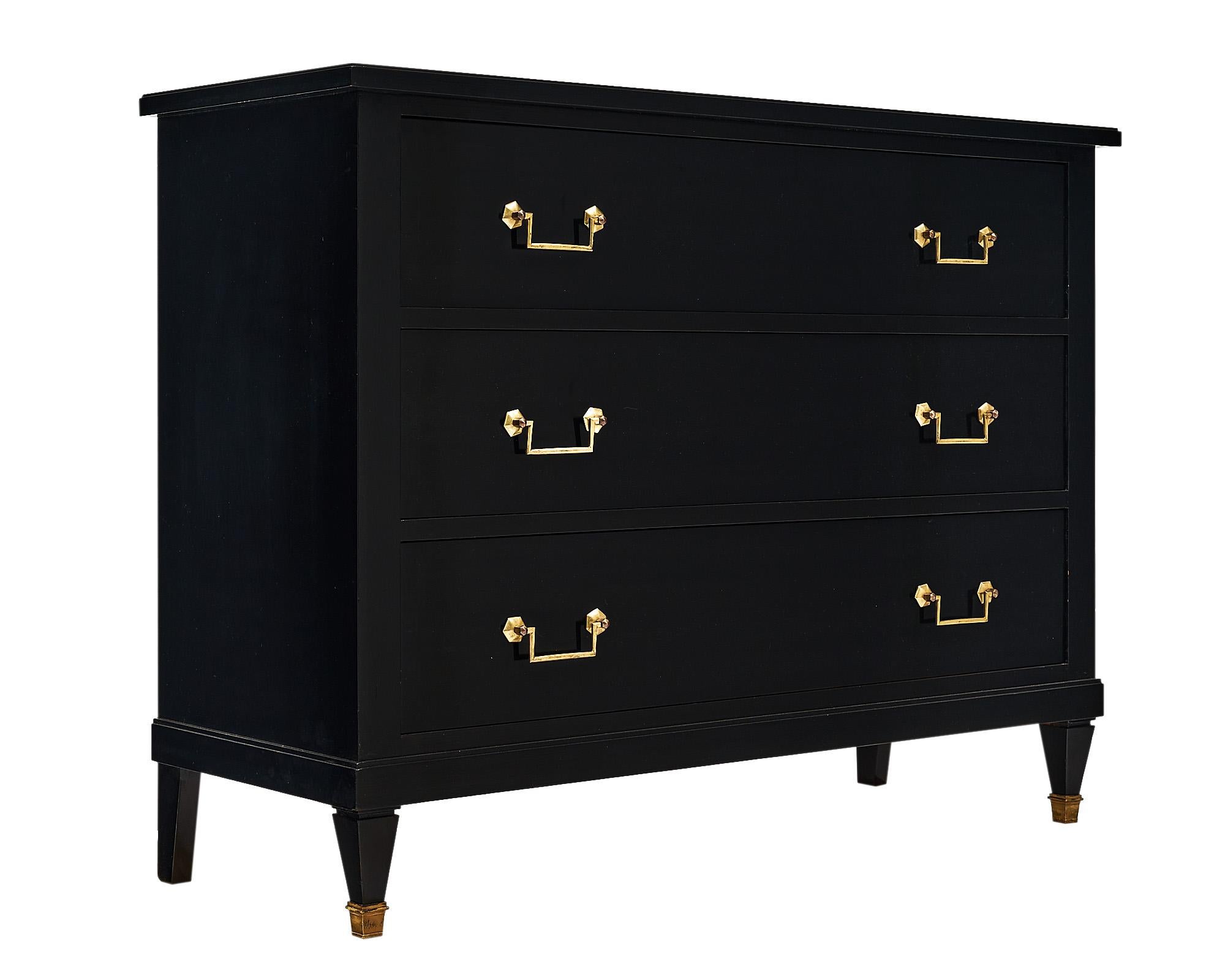 Chest of drawers, French, made of mahogany that has been ebonized and finished with a lustrous French polish. This piece has three dovetailed drawers and gilt brass handles. The clean lines lend itself perfectly to many functions. It is supported by