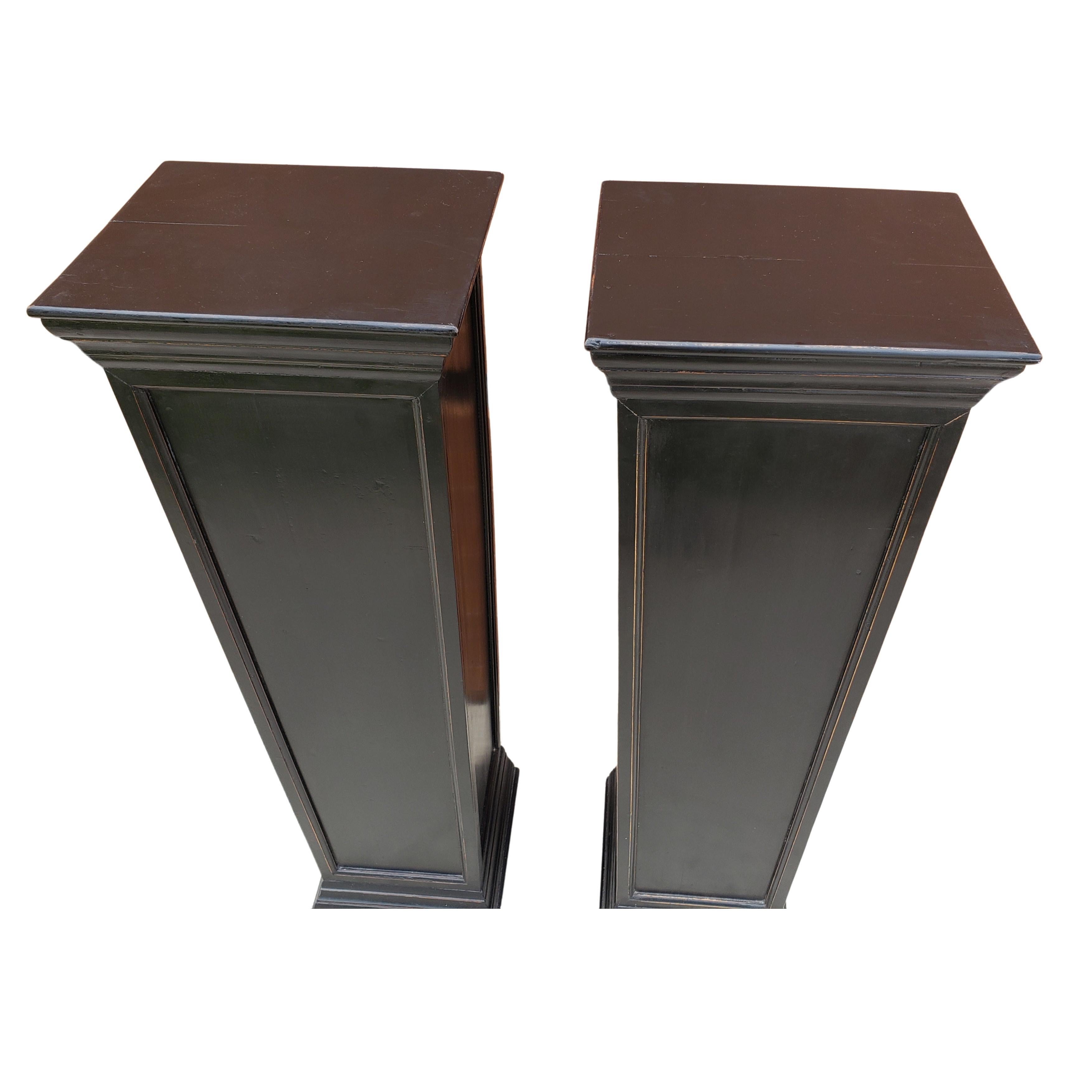 A pair directoire style ebonized fruitwood oblong pedestals.
Measure 15 inches in width, 12 inches in depth and stand 47 inches tall.