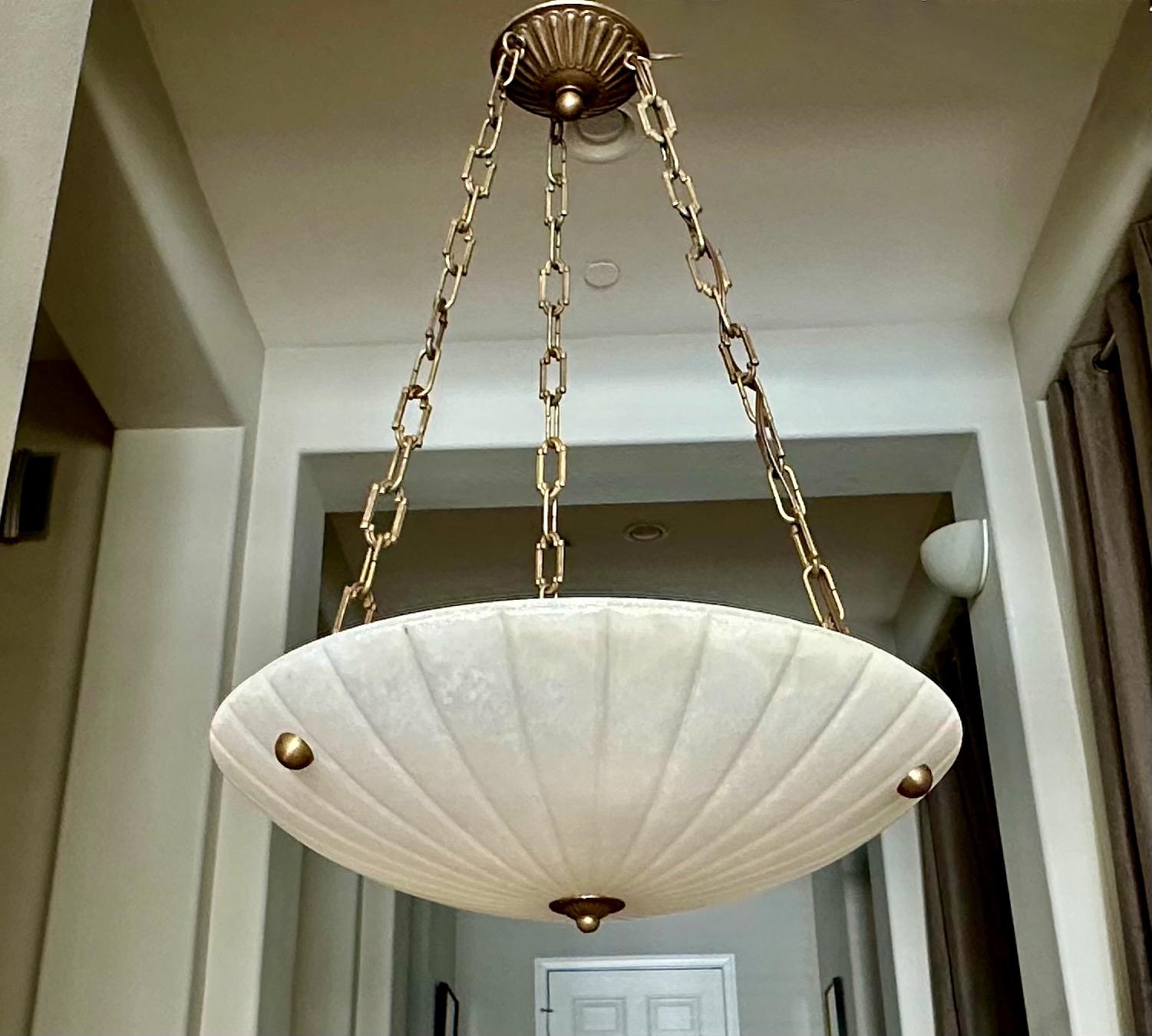 French alabaster pendant light with brass aged (antiqued) finish fittings in the Directoire style. Interior lighting uses 3 60-watt intermediate base bulbs (led recommended). Newly wired. 
