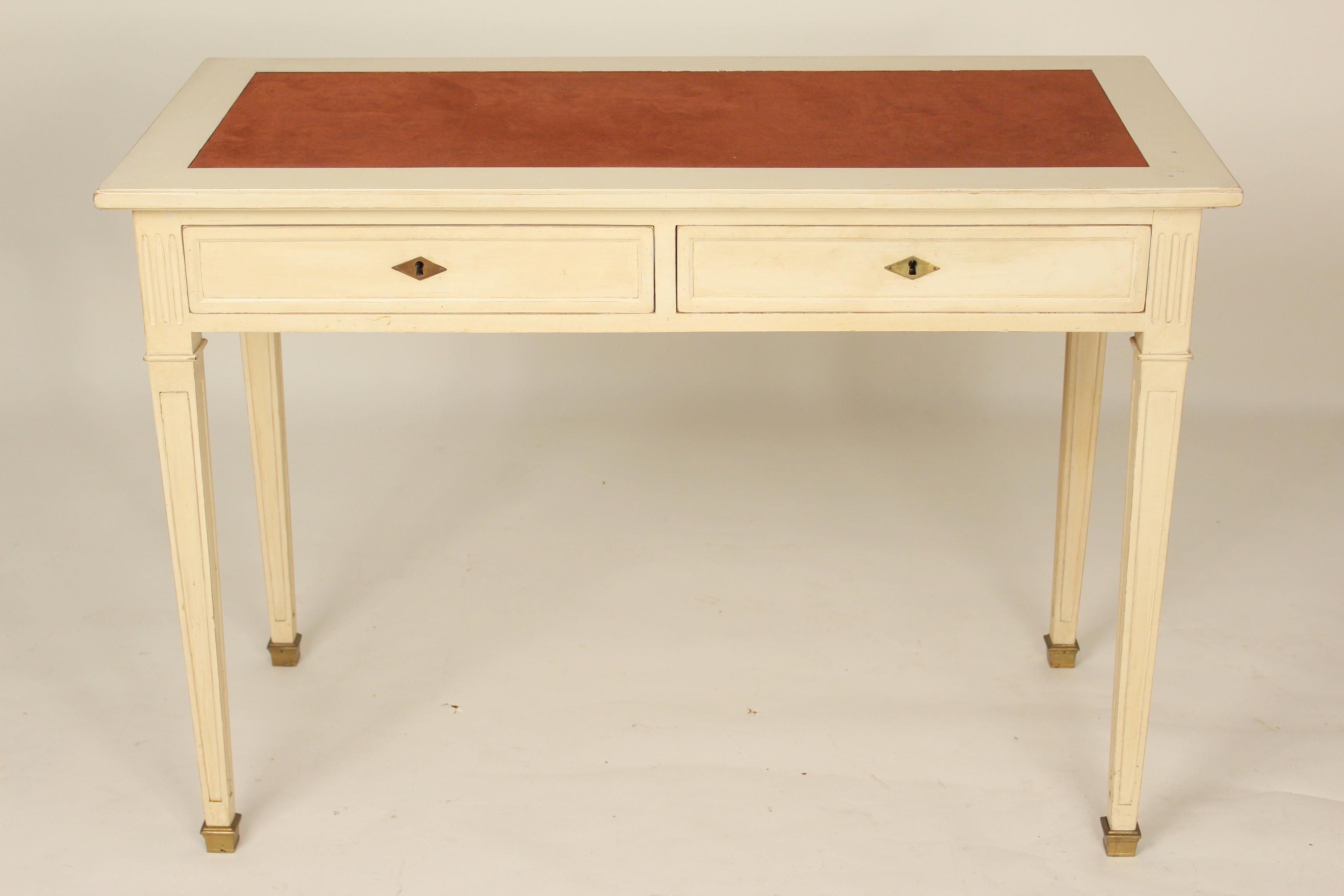 Directoire style painted writing table with suede top, brass escutcheons, bronze sabots and writing slides that pull on either end, circa mid-20th century. Handmade construction with mortise tenon and dowel outer construction and hand dovetailed