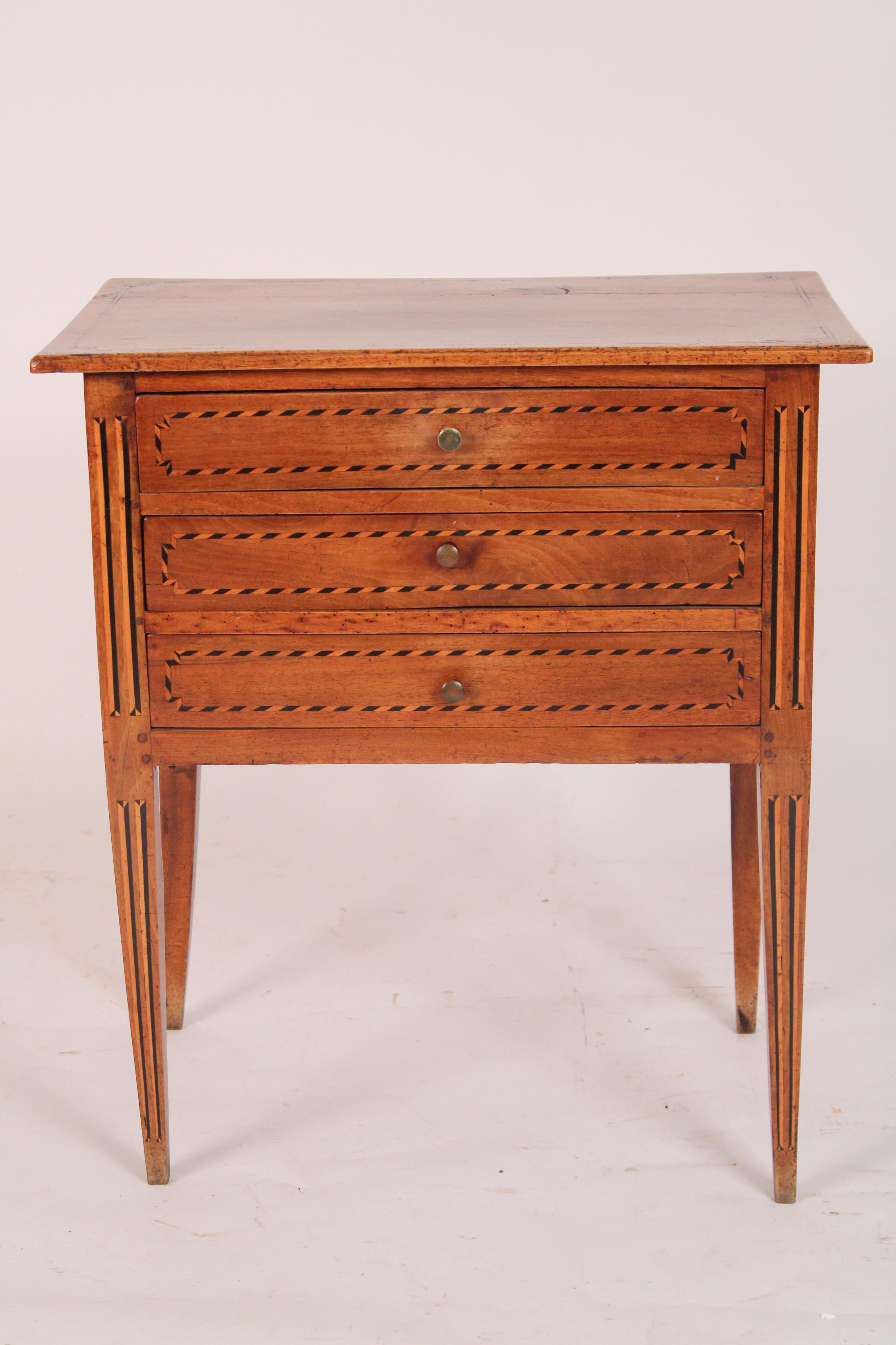 Directoire walnut 3 drawer chest of drawers / end table, early 19th century. With a two board rectangular top with thumb molded borders, 3 drawers each with ebony and tulip wood inlay,  sides with burl walnut panels, resting on ebony and tulip wood