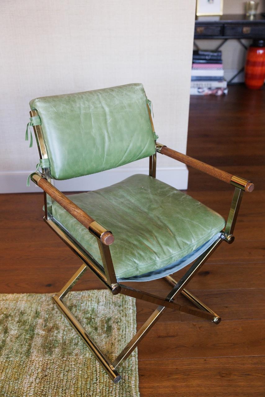 This pair of Mid-Century Director-style Armchairs bring vintage outdoor creativity and adventure into any interior living space. Made from Brass and Oak, and upholstered in a comfortable custom bottle-green leather upholstery from Kneedler Fauchere,