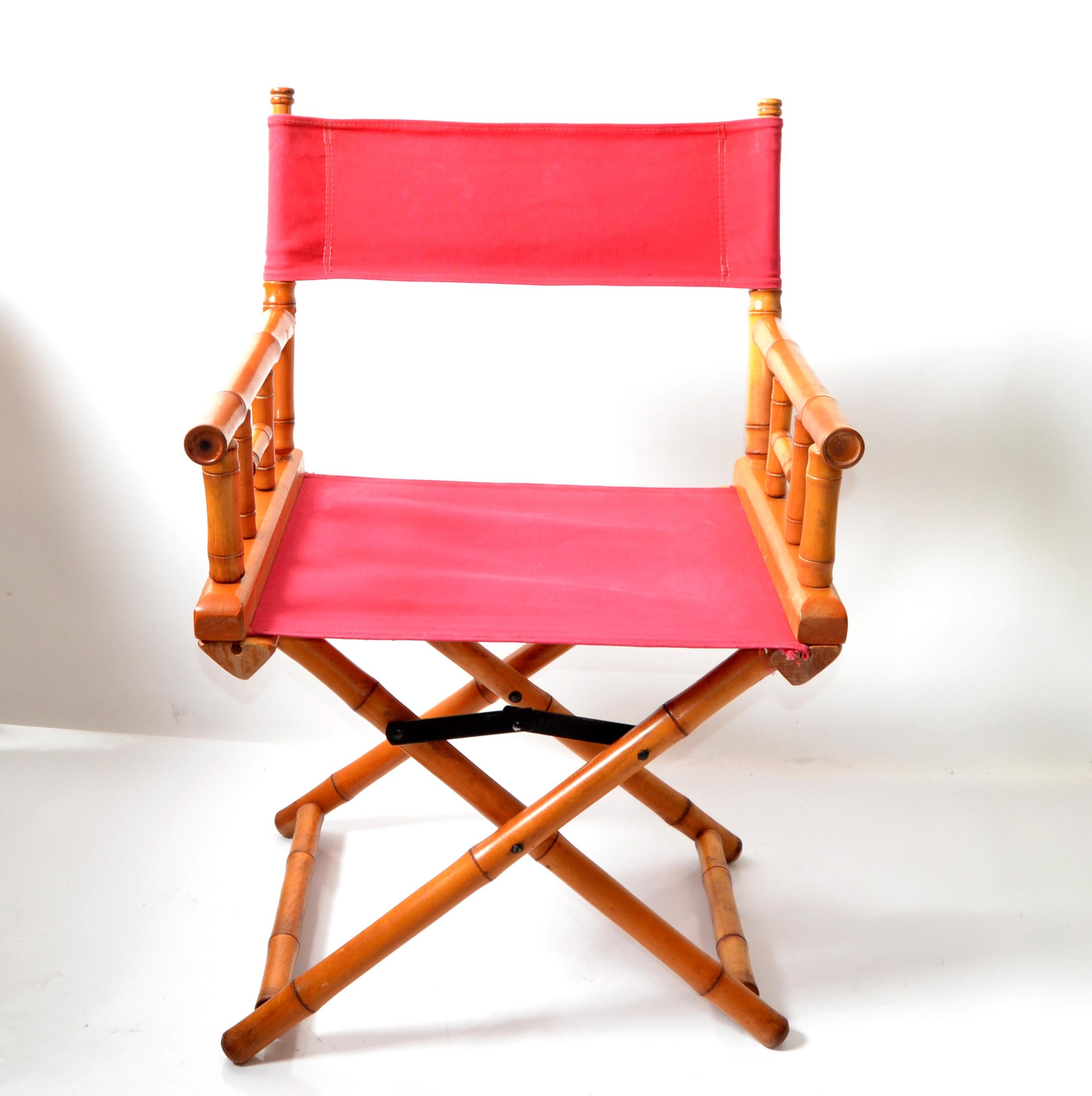 Mid-Century Modern coral red cottan canvas and bamboo wood folding director chair with canvas sling seat and back rests. 
Attributed to Telescope Furniture Company, circa 1970's, Made in the USA, unsigned.
The chair is in very good, original