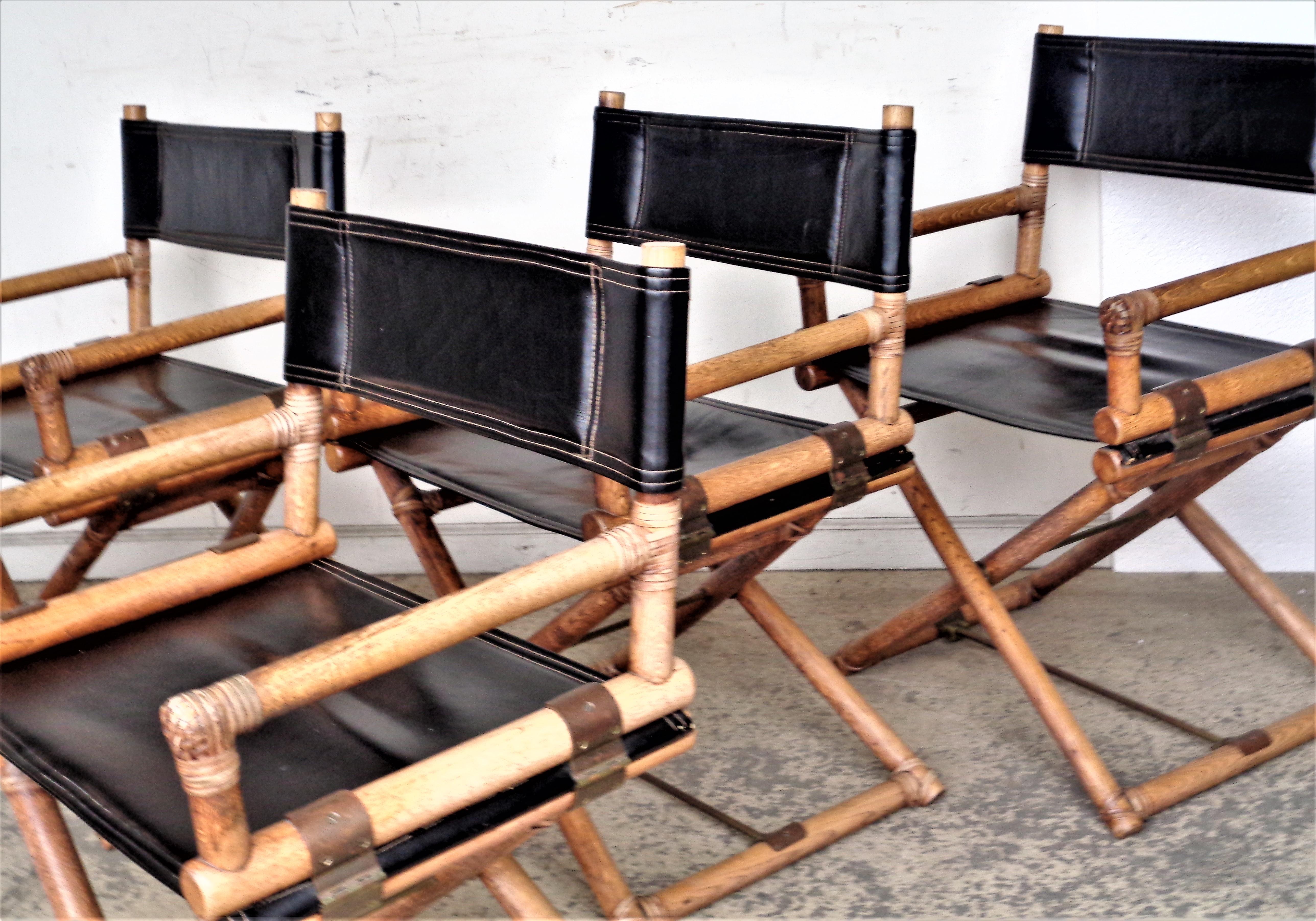 Set of four McGuire campaign style director's x-chairs with oak frames, rawhide leather bindings, brass fittings, high quality black vinyl seats and backs. Overall beautifully aged original surface color patina ( wood has not been refinished or the
