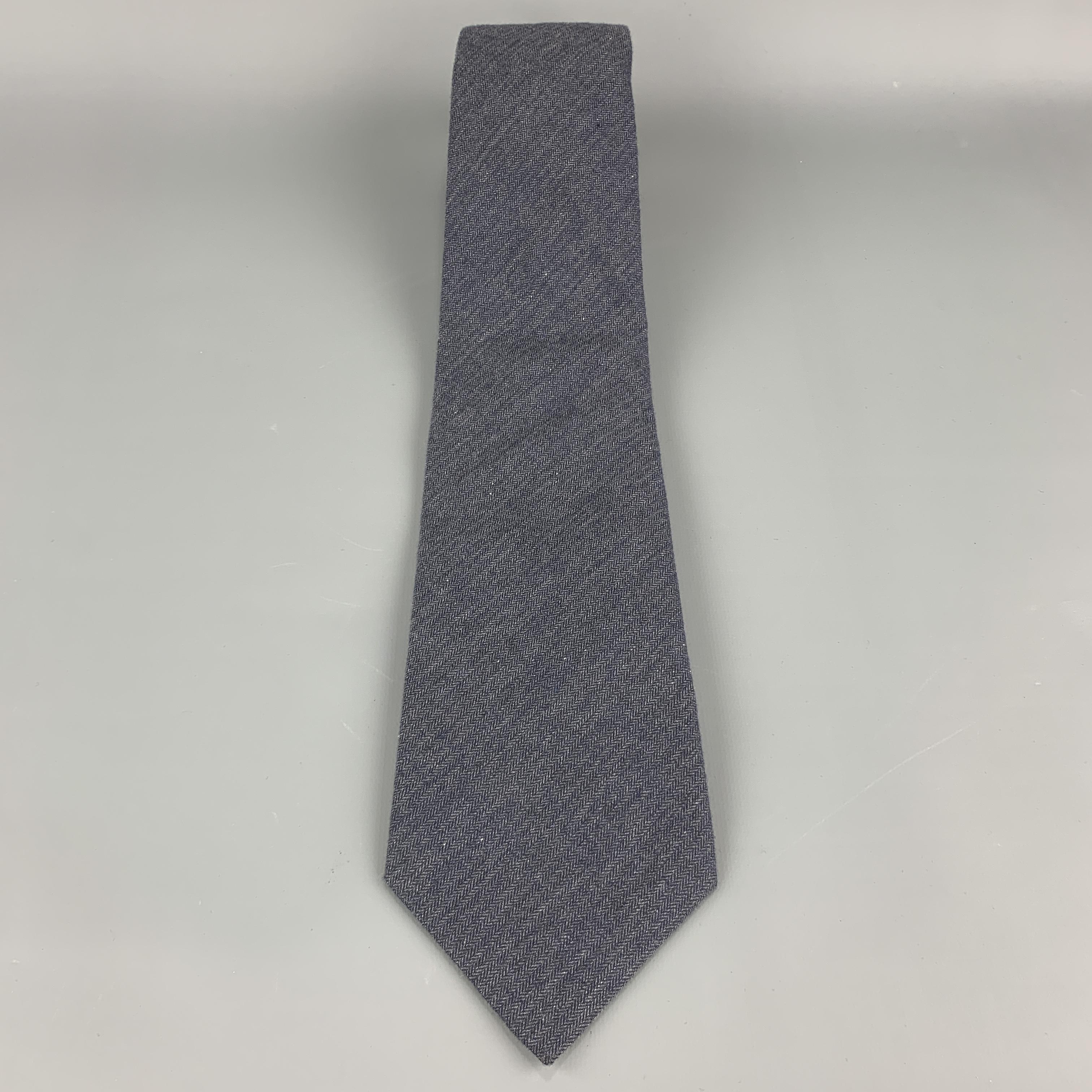 DIRK BIKKEMBERGS necktie comes in muted navy blue cotton with all over herringbone print. Made in Italy.

Excellent Pre-Owned Condition.

Width: 3.75 