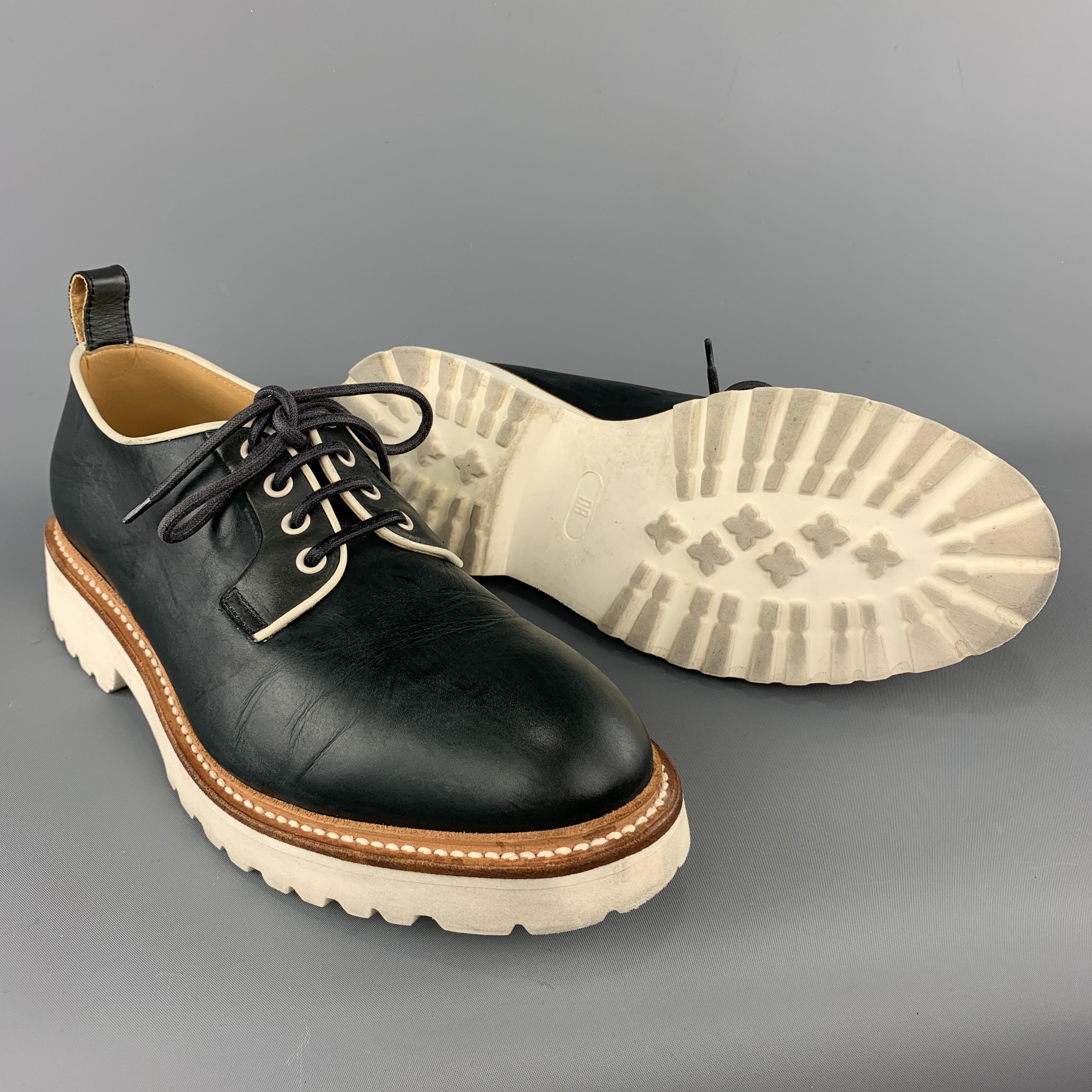 Dirk Bikkembergs lace ups come in teal navy smooth leather with a tan leather midsole and white rubber sole.  Made in Italy.
 

Very Good Pre-Owned Condition.
Marked: IT 44

Outsole: 12.45 x 4.5 in.