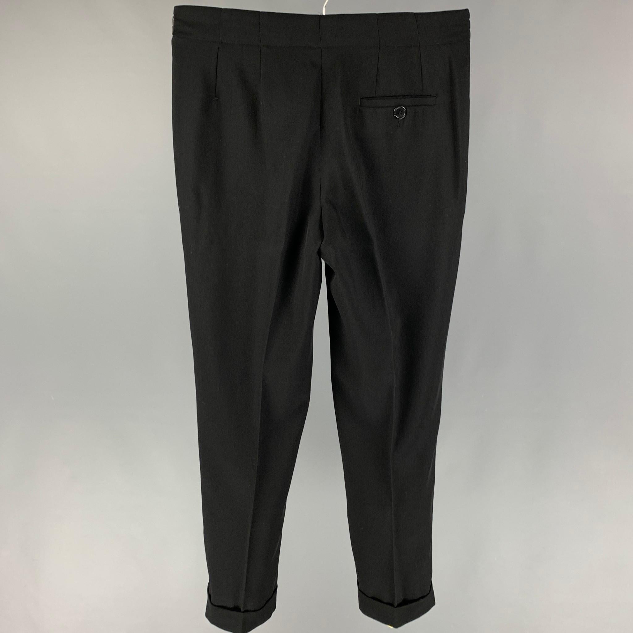 DIRK BIKKEMBERGS dress pants comes in a black rayon featuring a cuffed leg, flat front, drawstring, and a zip fly closure. Made in Italy. 

Very Good Pre-Owned Condition.
Marked: 48

Measurements:

Waist: 32 in.
Rise: 11.5 in.
Inseam: 30 in.