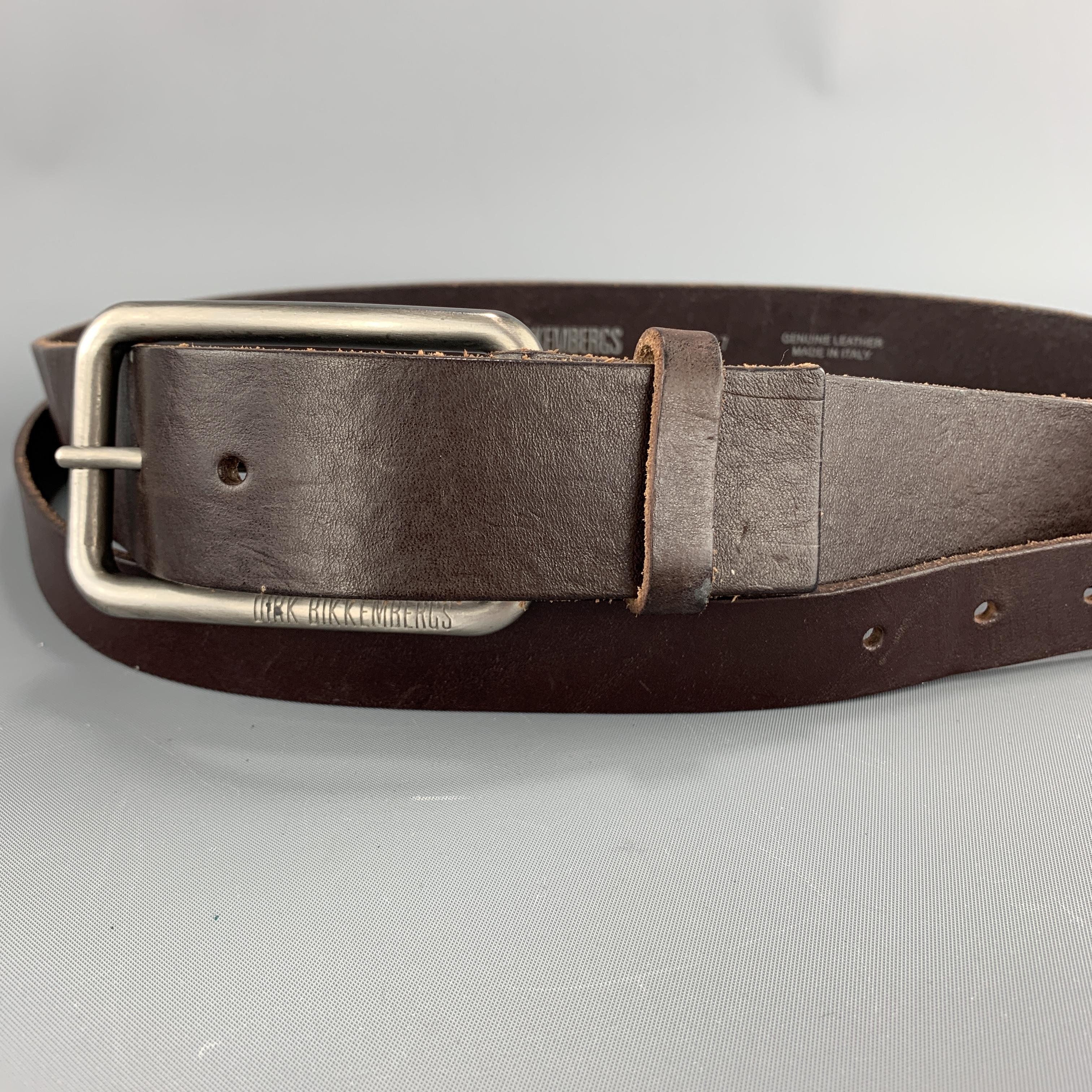 DIRK BIKKEMBERGS belt comes in deep brown leather with an oversized silver tone buckle closure and thin layered overlay belt. Made in Italy.

Excellent Pre-Owned Condition.
Marked: IT 44

Length: 38.5 in.
Width: 1.5 in.
Fits: 30.5 - 34.5 in.