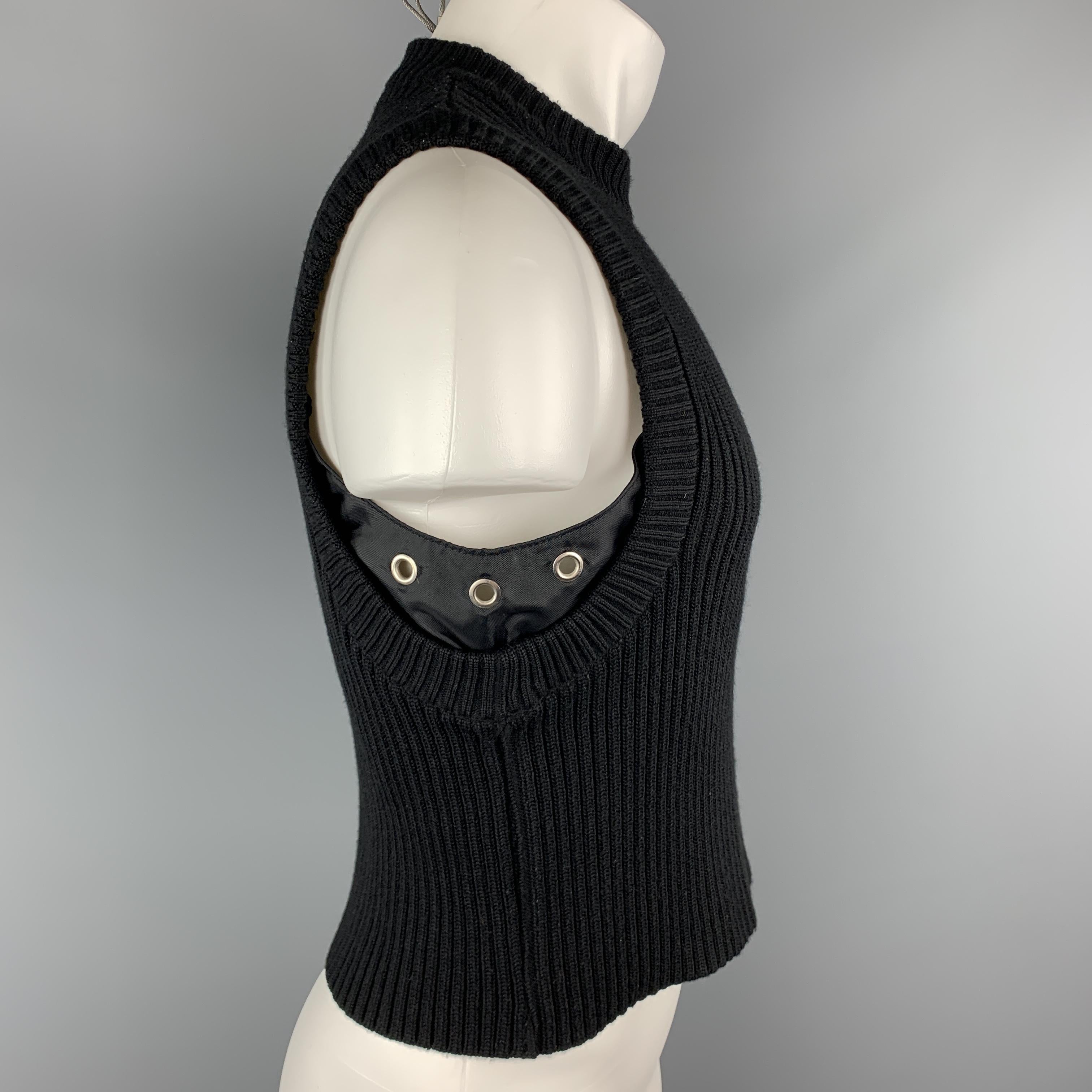 DIRK BIKKEMBERGS crop top comes in black wool ribbed knit with a crewneck and nylon grommet side details. Made in Belgium.

Excellent Pre-Owned Condition.
Marked: S

Measurements:

Shoulder: 13 in.
Chest: 40 in.
Length: 21 in.