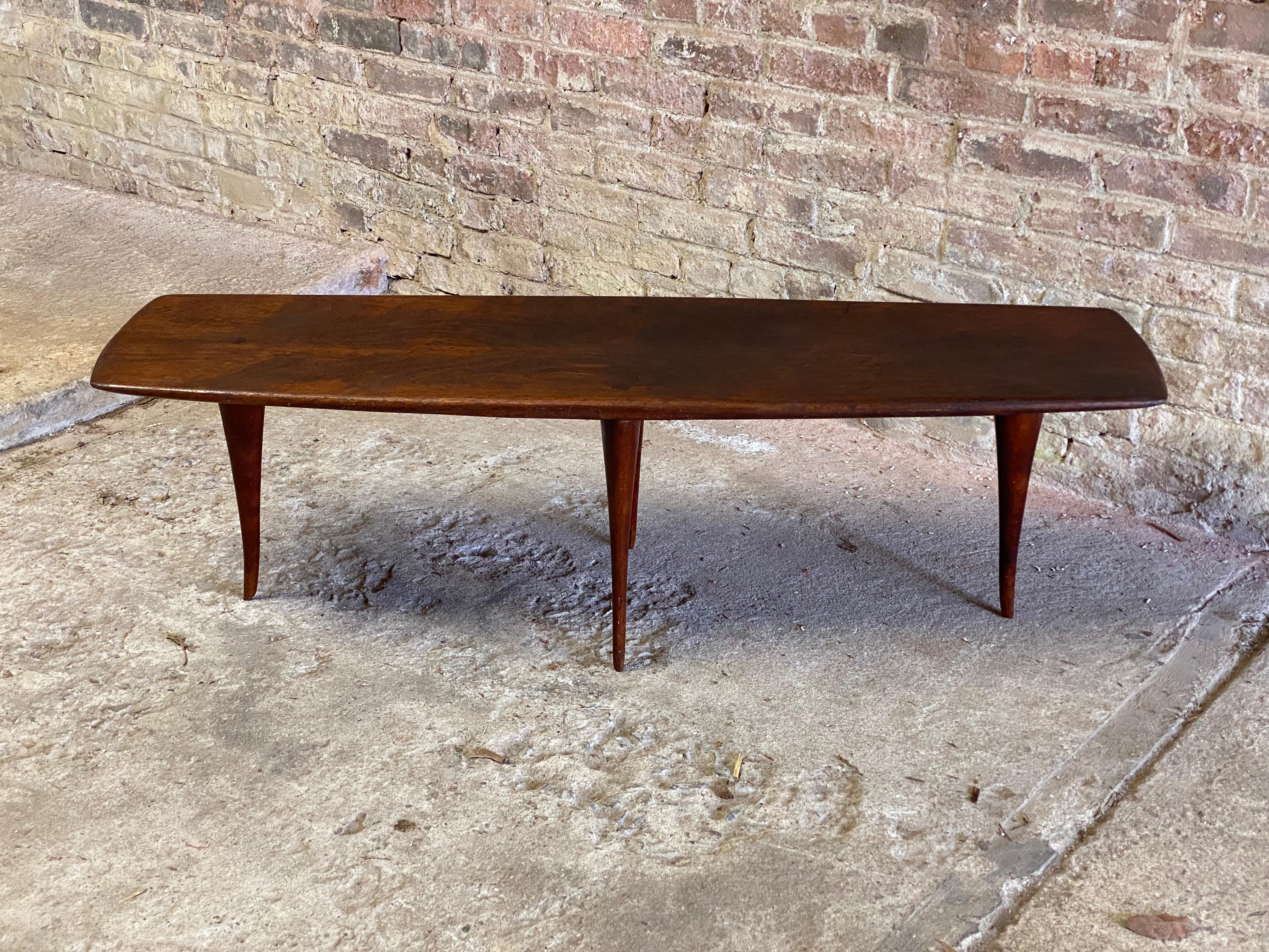 Signed and dated Dirk Rosse (1925-2014) solid black walnut American Studio Crafts movement coffee table. Featuring a solid single board walnut top, visible splined leg joinery, and sculptural tapered leg and foot. The bottom reveals his initials and
