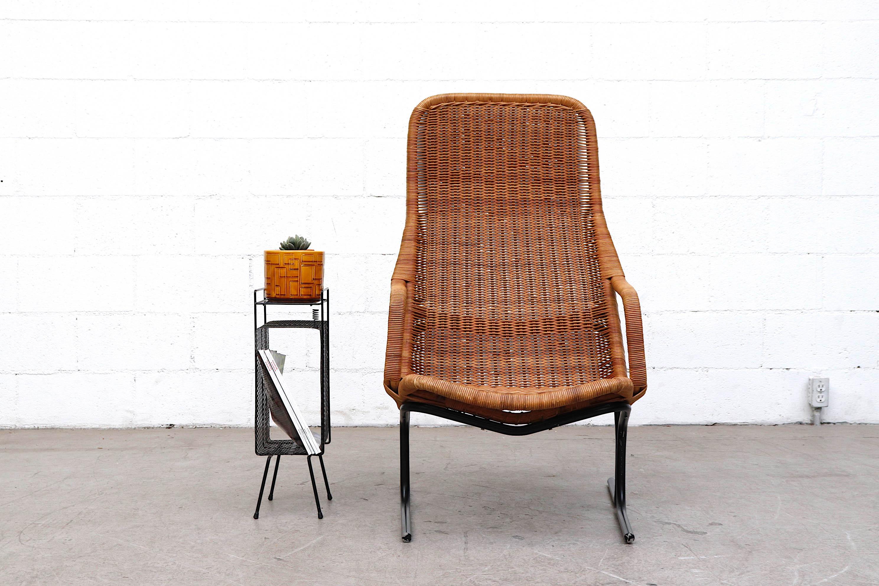 Beautiful midcentury high back woven rattan lounge chair with black enameled metal tubular frame and head cushion in original condition. Visible signs of wear with minimal rattan loss. Shown with cute little Mategot inspired side table.