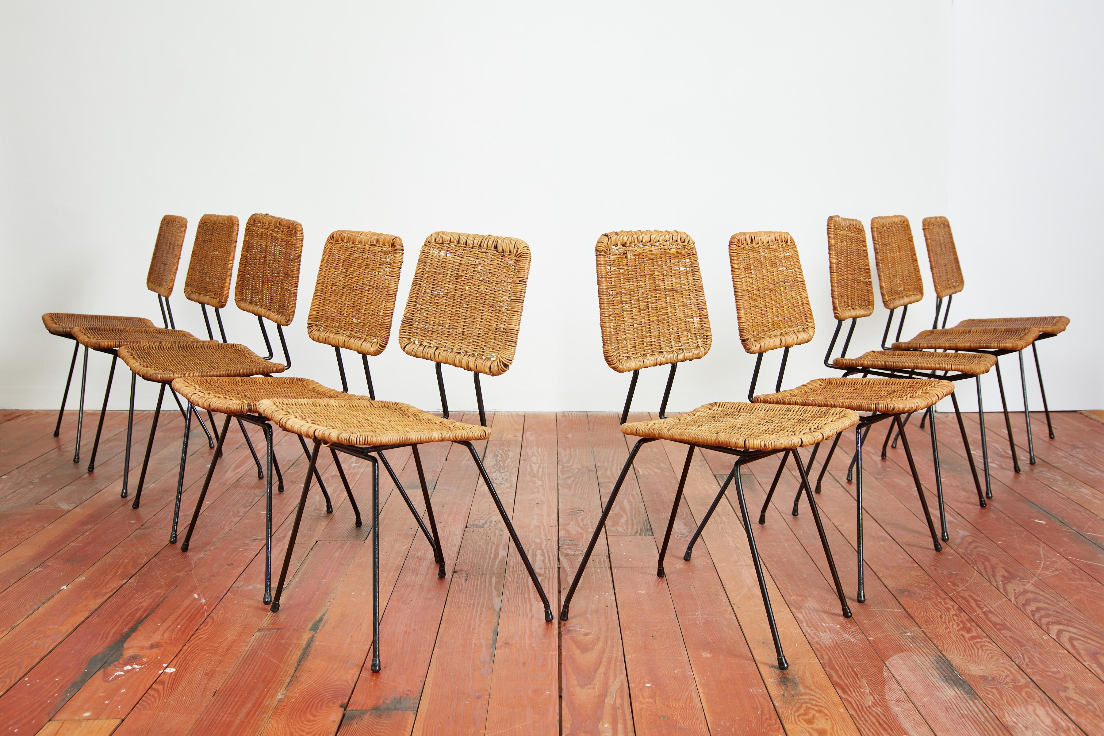 Set of 10 dining chairs by Dutch designer Dirk Van Sliedregt. 
Black iron bases with sculptural wicker seats and floating backs. 

