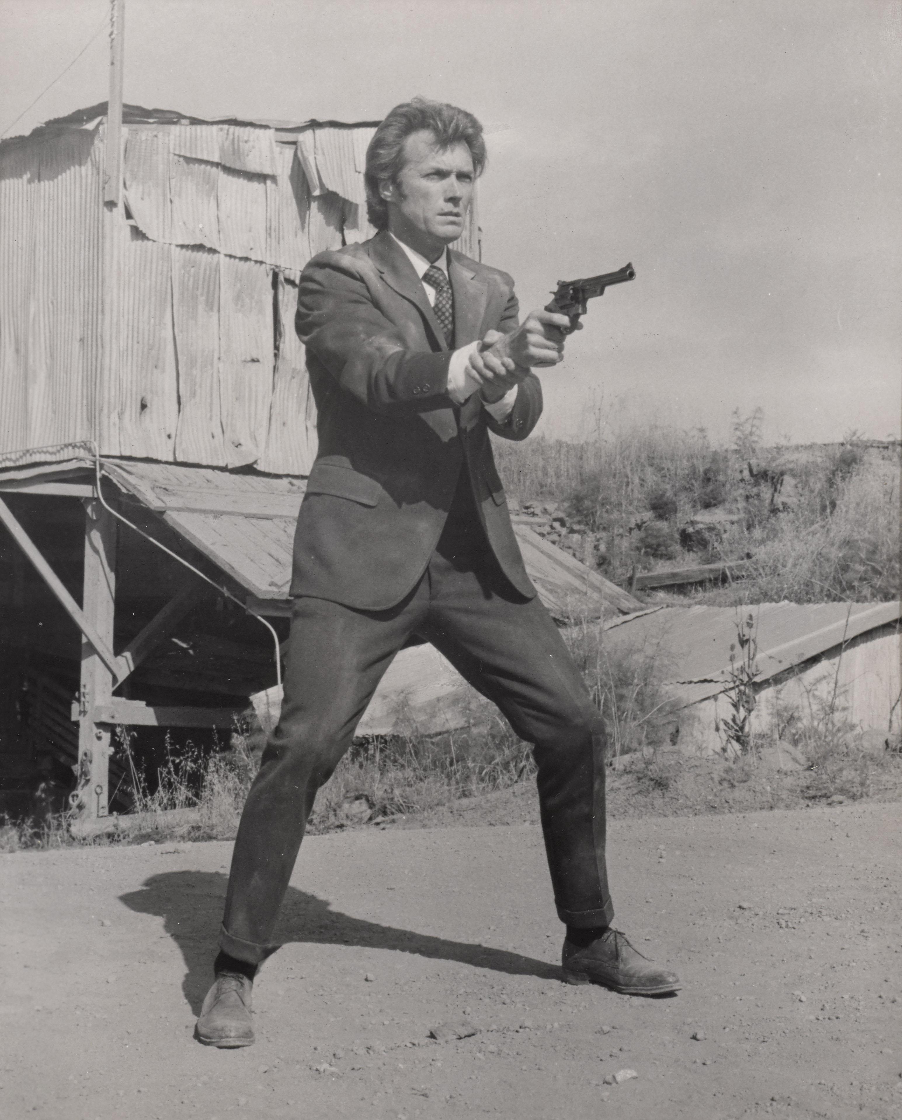 Original photographic production still for Clint Eastwood's classic Dirty Harry.
This film was directed by Don Siegel. 
This piece is framed in a Sapele wood frame with acid free card mounts and UV Plexiglass.
The size given is before