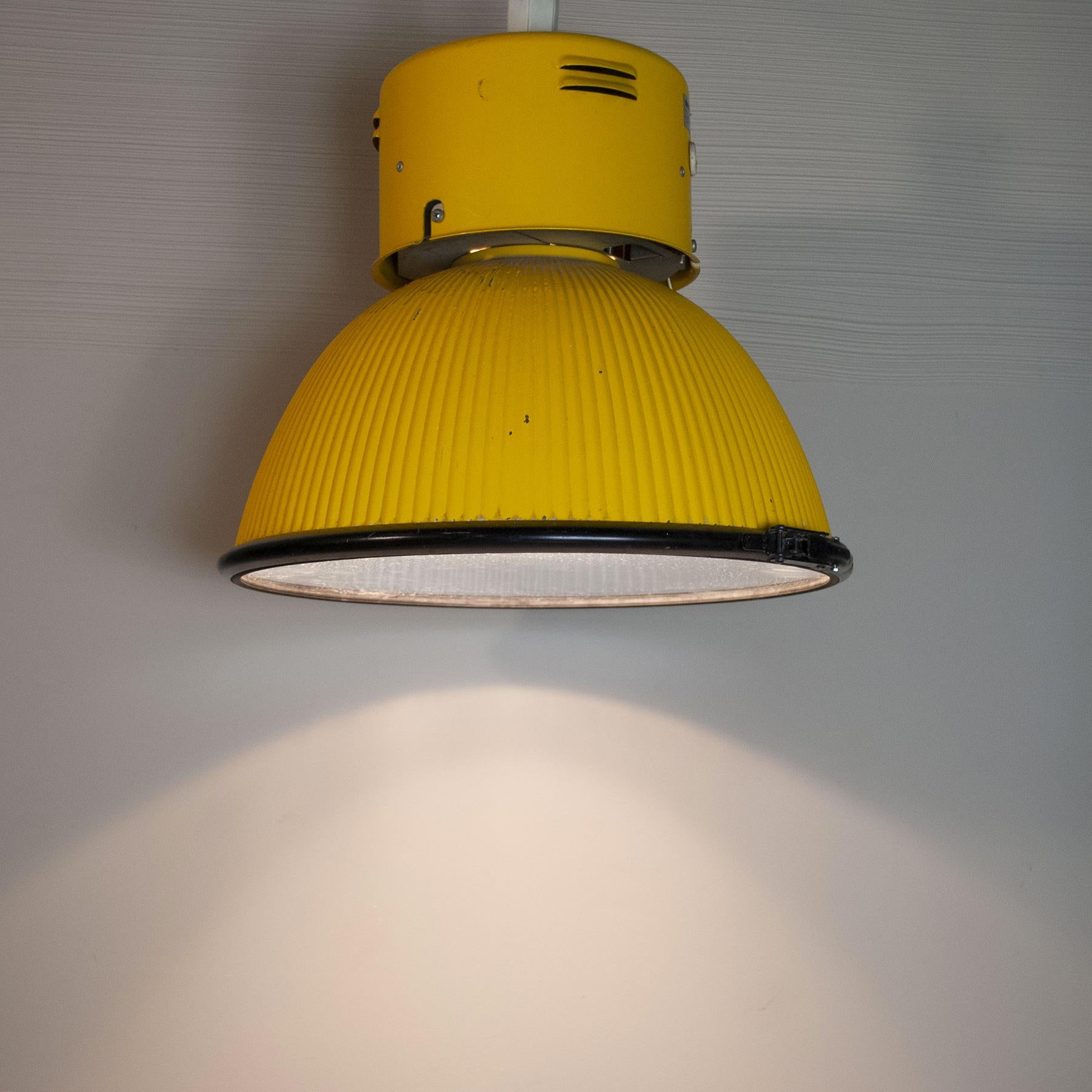 Available pair of large industrial lamps from the 1980s, Disano brand in yellow lacquered aluminum.