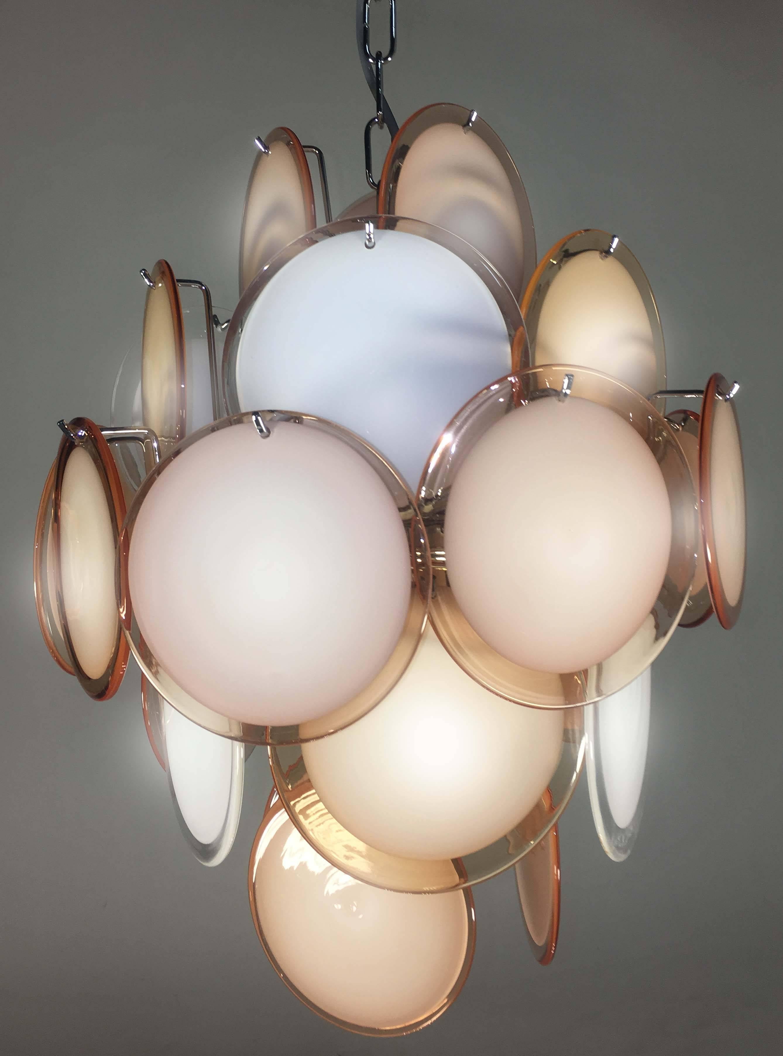Spectacular multi-color chandelier by Vistosi made in Murano. Each chandelier is formed by 27 multicolor discs of precious Murano glass are arranged on floor levels. Nine lights. Measures: Height without chain 50 cm. Available also with white