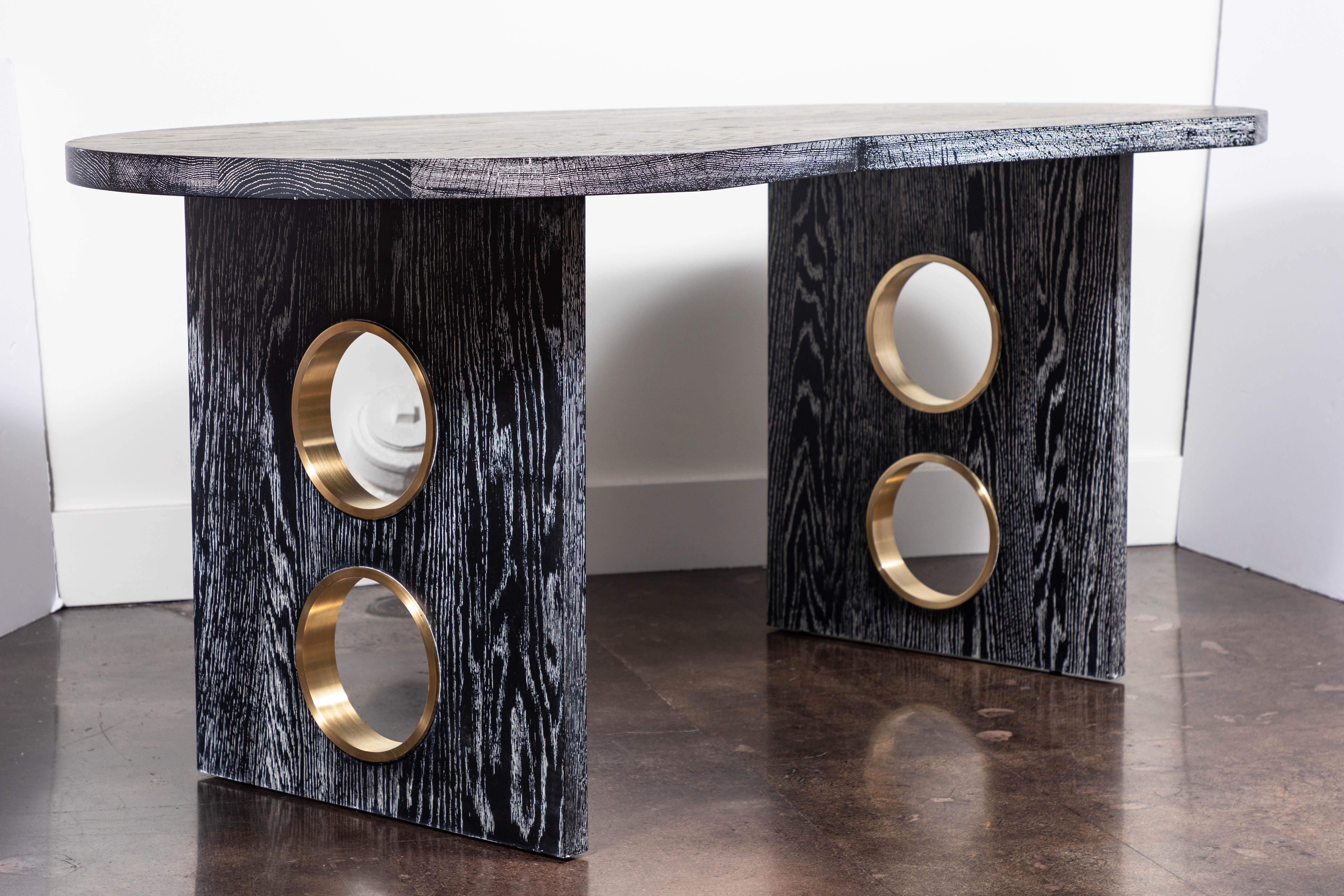 Glamorous desk in cerused oak with brass porthole details on the legs by On Madison. To order, 8-10 weeks. Custom ceruse colors and choice of brass, chrome or nickel metal detail available.