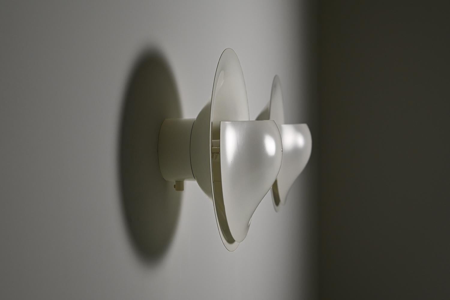 Disc wall lamps C-1558 by Raak, 1980s The Netherlands. These wall lamps were produced by Raak in Aalsmeer during the 1980s, a period when the Dutch lighting manufacturer was known for its clean, architectural designs. The lamps feature a circular