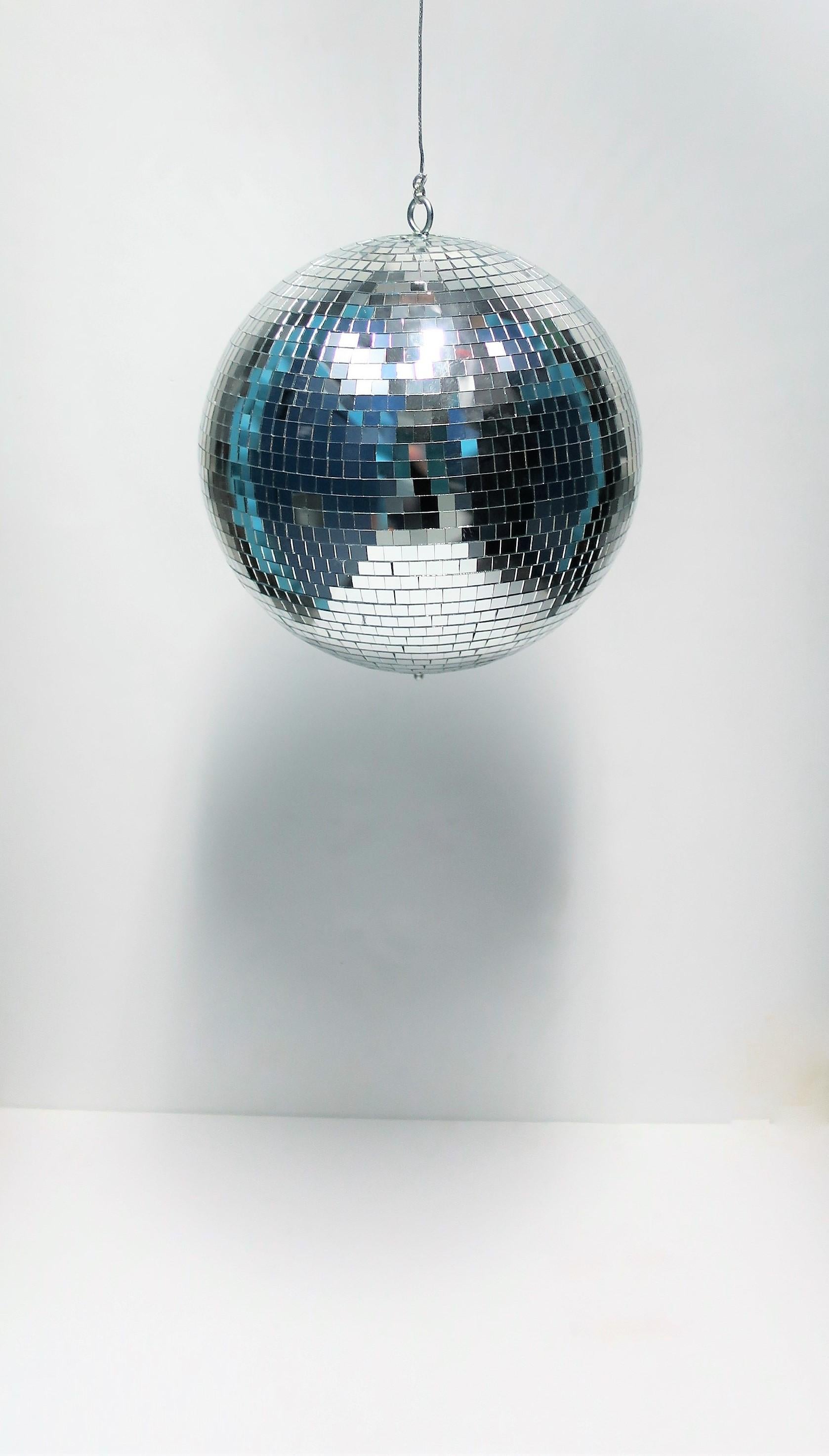 A 1970s Modern style disco ball in mirrored glass. 

Ball measures: 11
