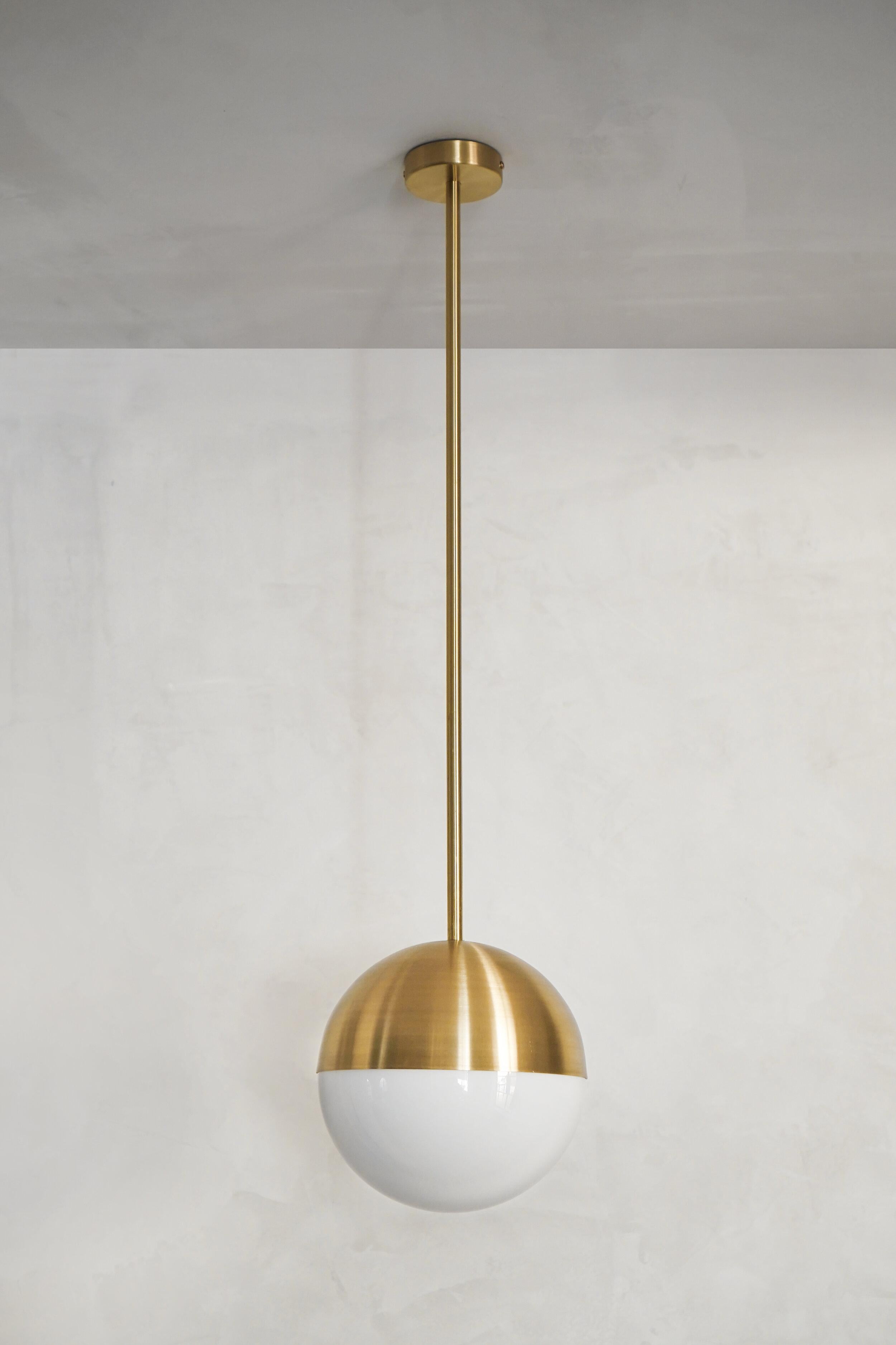 Disco half & half pendant by Contain
Dimensions: D 20 x H 100 cm (custom length).
Materials: brass structure and opal glass.
Available in different finishe. 

All our lamps can be wired according to each country. If sold to the USA it will be