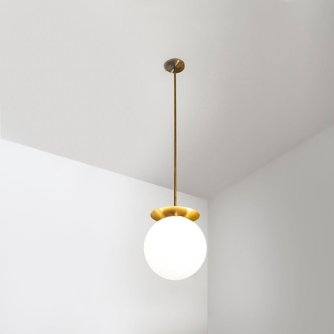 Disco Pendant 20 by Contain
Dimensions: D 20 x H 100 cm (custom length).
Materials: Brass structure and opal glass.

Available in different finishes and dimensions (Available in 18cm Ø / 20cm Ø / 30cm Ø / 40cm Ø x custom length). Please contact