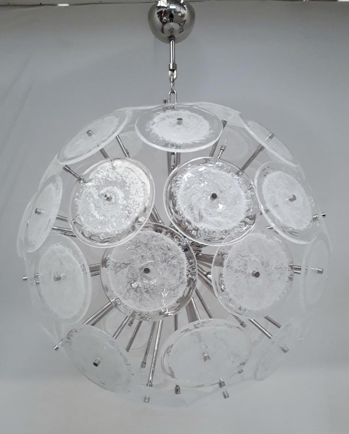 Italian round Sputnik chandelier with clear Murano glass discs hand blown with bubbles using Pulegoso technique, mounted on nickel metal finish frame, by Fabio Ltd, made in Italy
6 lights / E12 or E14 type / max 40W each
Measures: Diameter 27.5