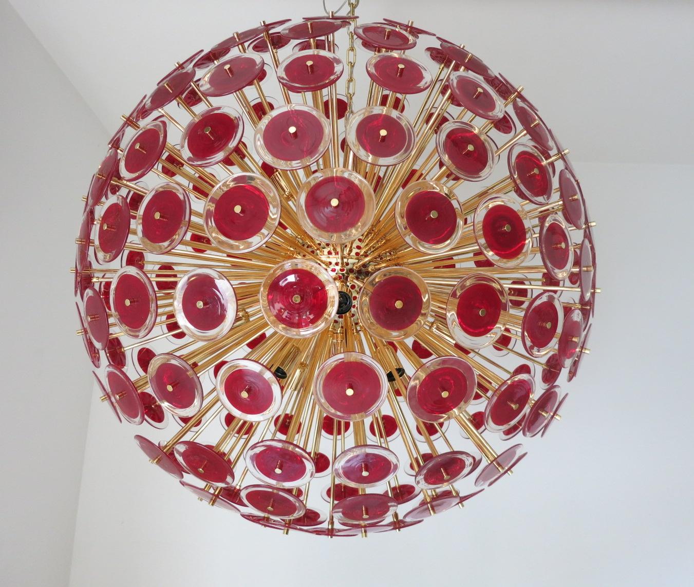 Italian round sputnik chandelier with red and clear Murano glass discs mounted on 24-karat gold plated metal frame by Fabio Ltd / Made in Italy
16 lights / E26 or E27 type / max 60W each
Measures: Diameter 43.5 inches, height 43.5 inches plus chain
