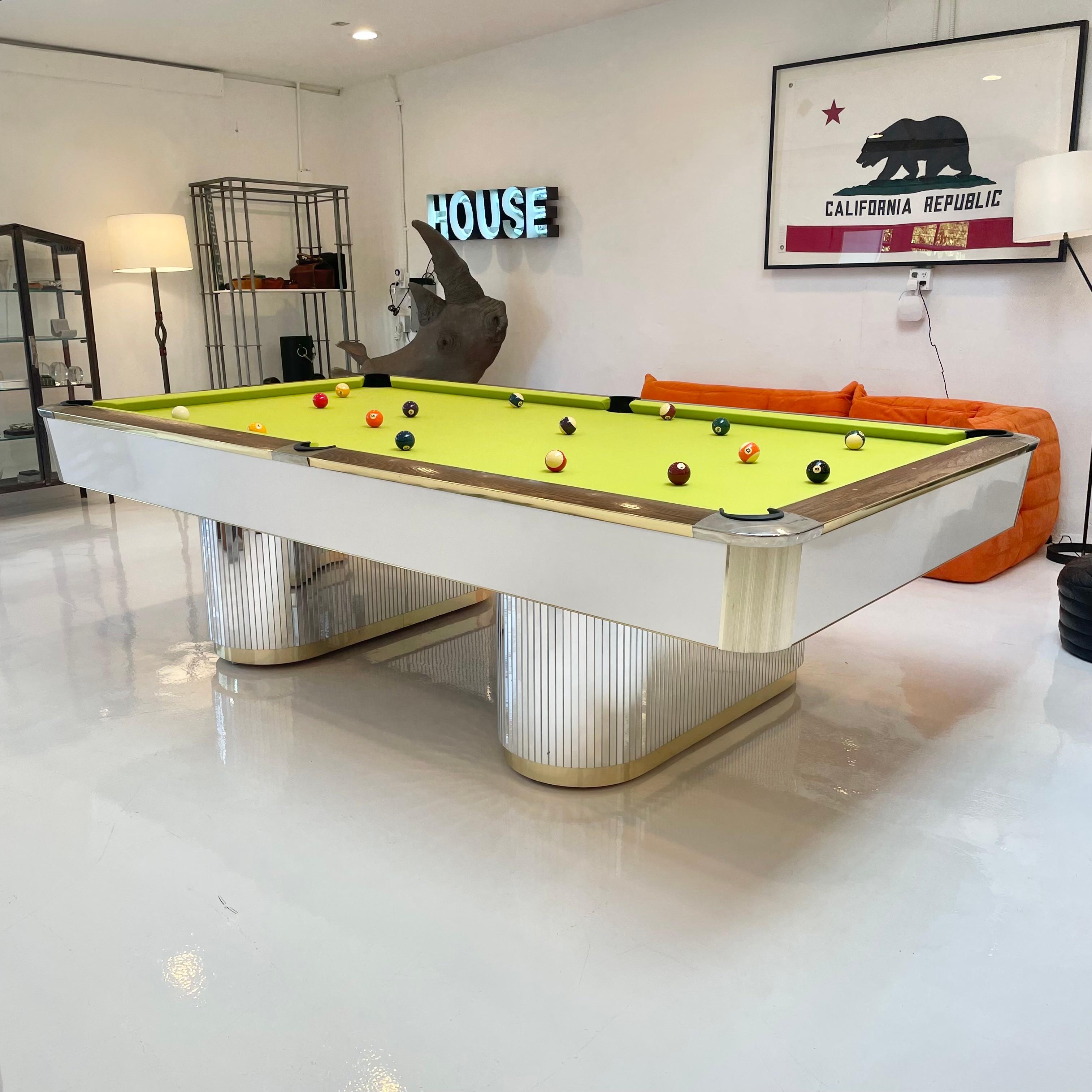 Wonderfully chic snow white, brass and glass pool table from the 1980s. Full length 9 foot table. Handmade by Murrey & Sons in Los Angeles. Nacre (Mother-of-Pearl) markers inlaid in stained oak railings. Excellent condition to Formica panels.