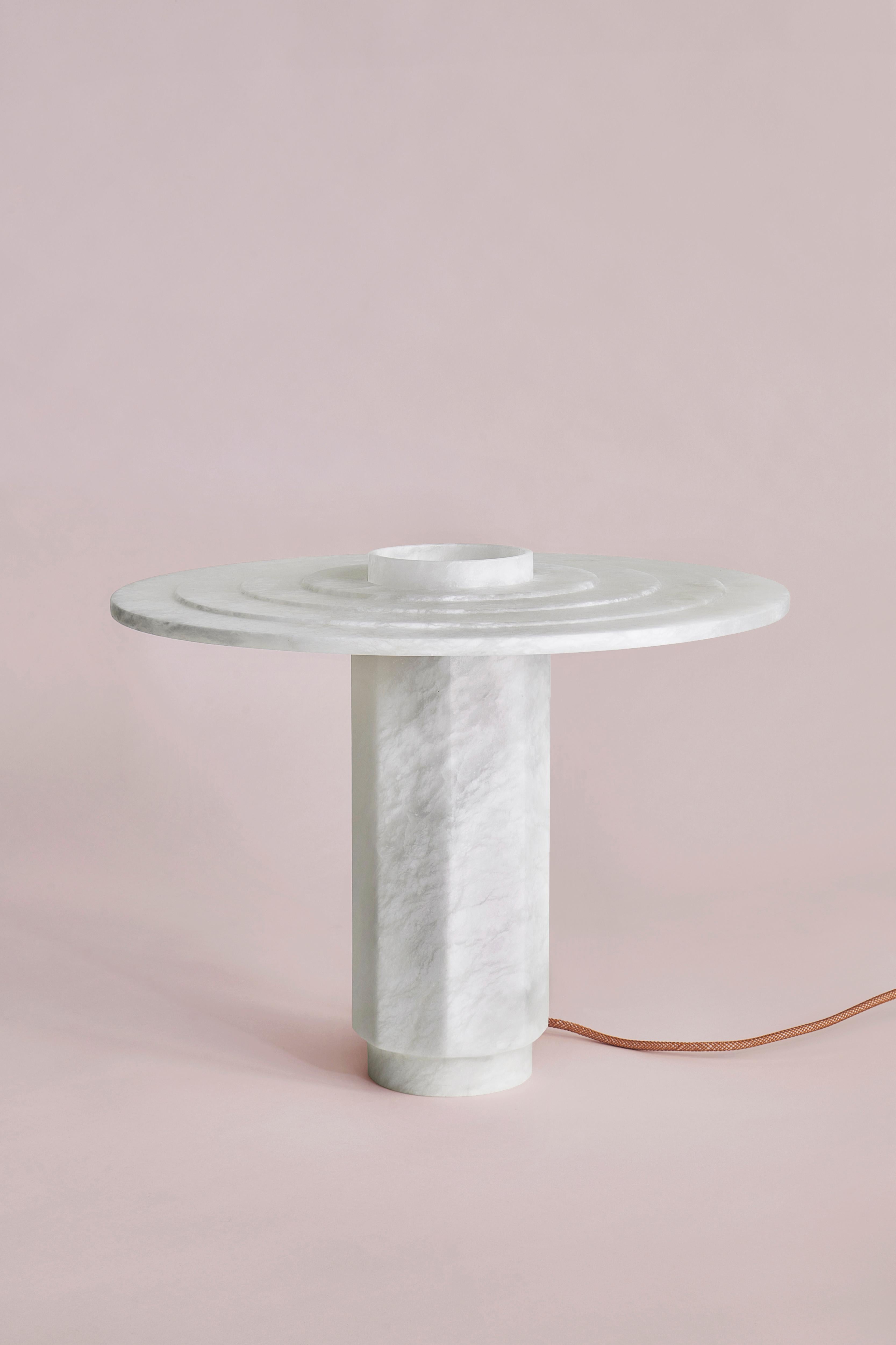 Disco Table Lamp by SB26
Dimensions: W 45 x D 45 x H 37 cm
Materials: Alabaster, LED Source.

In a consistently geometric vocabulary, this family of lamps unveils the
translucent and organic nature of alabaster.
A contrast of shapes and