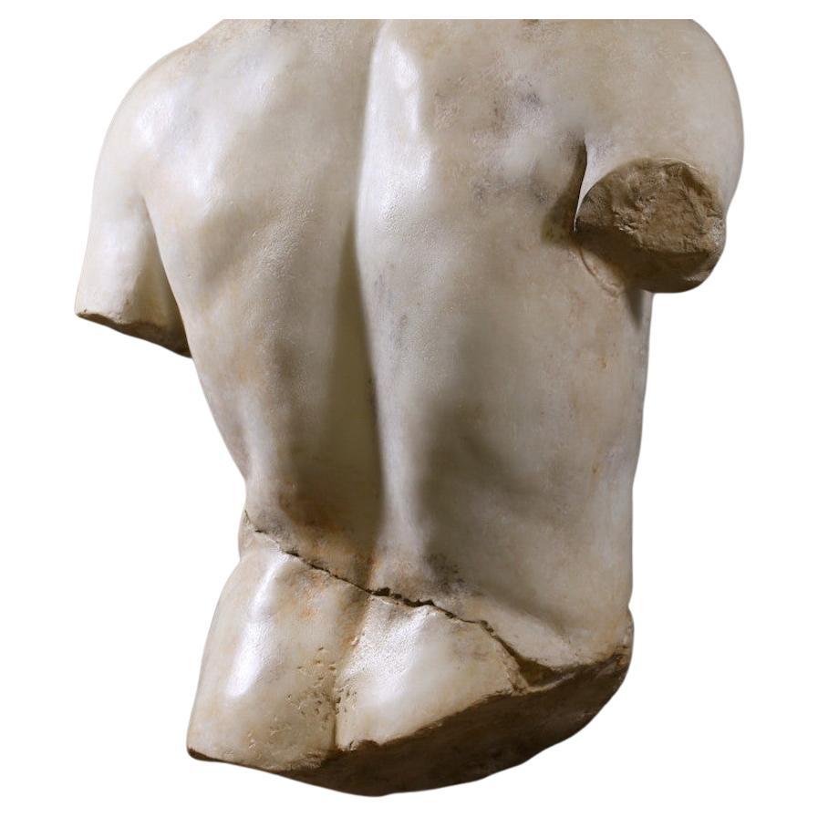 This partial torso of a discus thrower reproduces a fragment of the original bronze statue, now lost, created by the Greek sculptor Naucydes in the early 4th century BC. 
A reproduction of the whole statue is on display in the Louvre Museum's