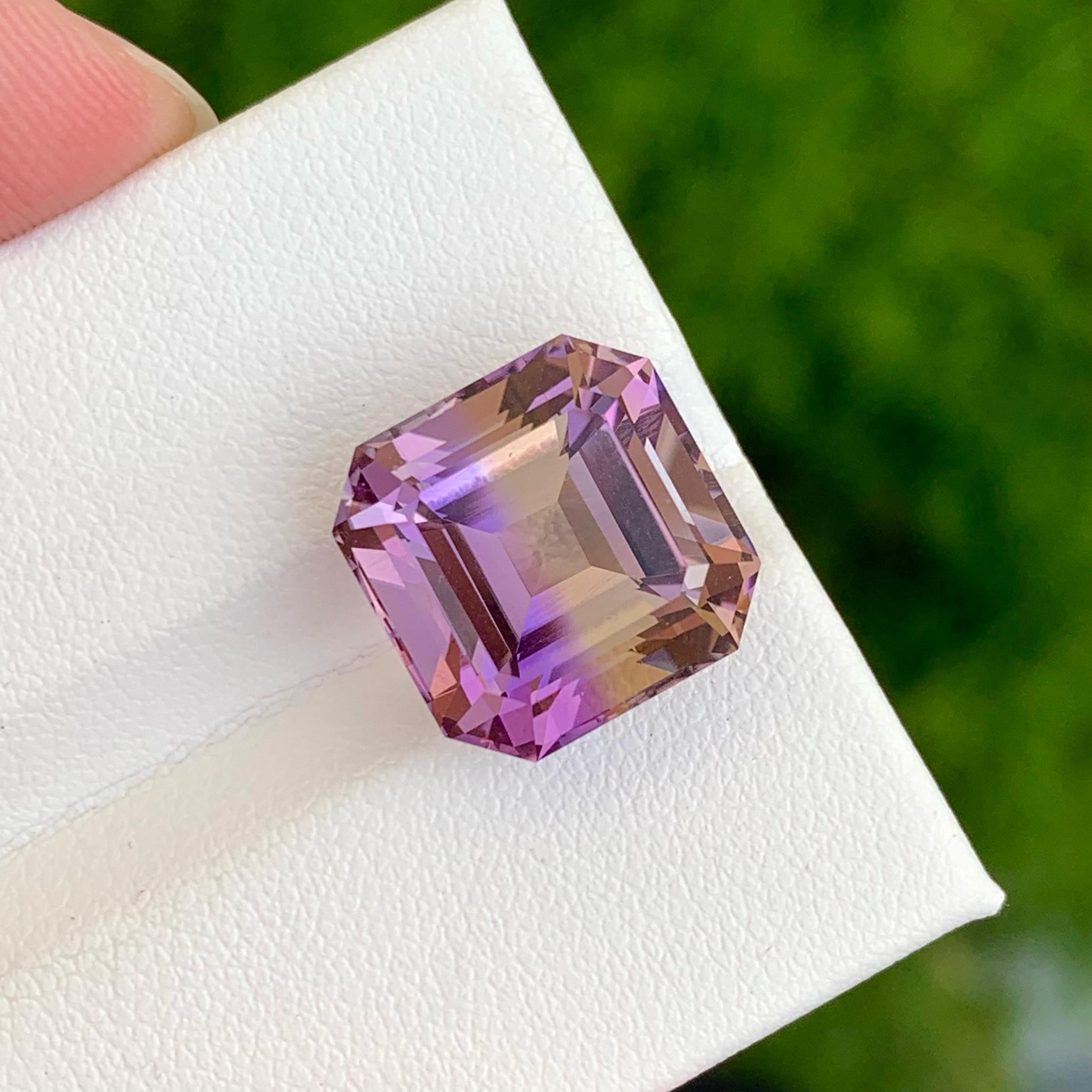 Weight 13.45 carats 
Dimensions 13.5x13.5x11.0 mm
Treatment none 
Origin Bolivia
Clarity loupe clean
Shape octagon 
Cut Asscher 

Ametrine's name perfectly reflects its dual nature, combining amethyst and citrine. The gemstone features distinct