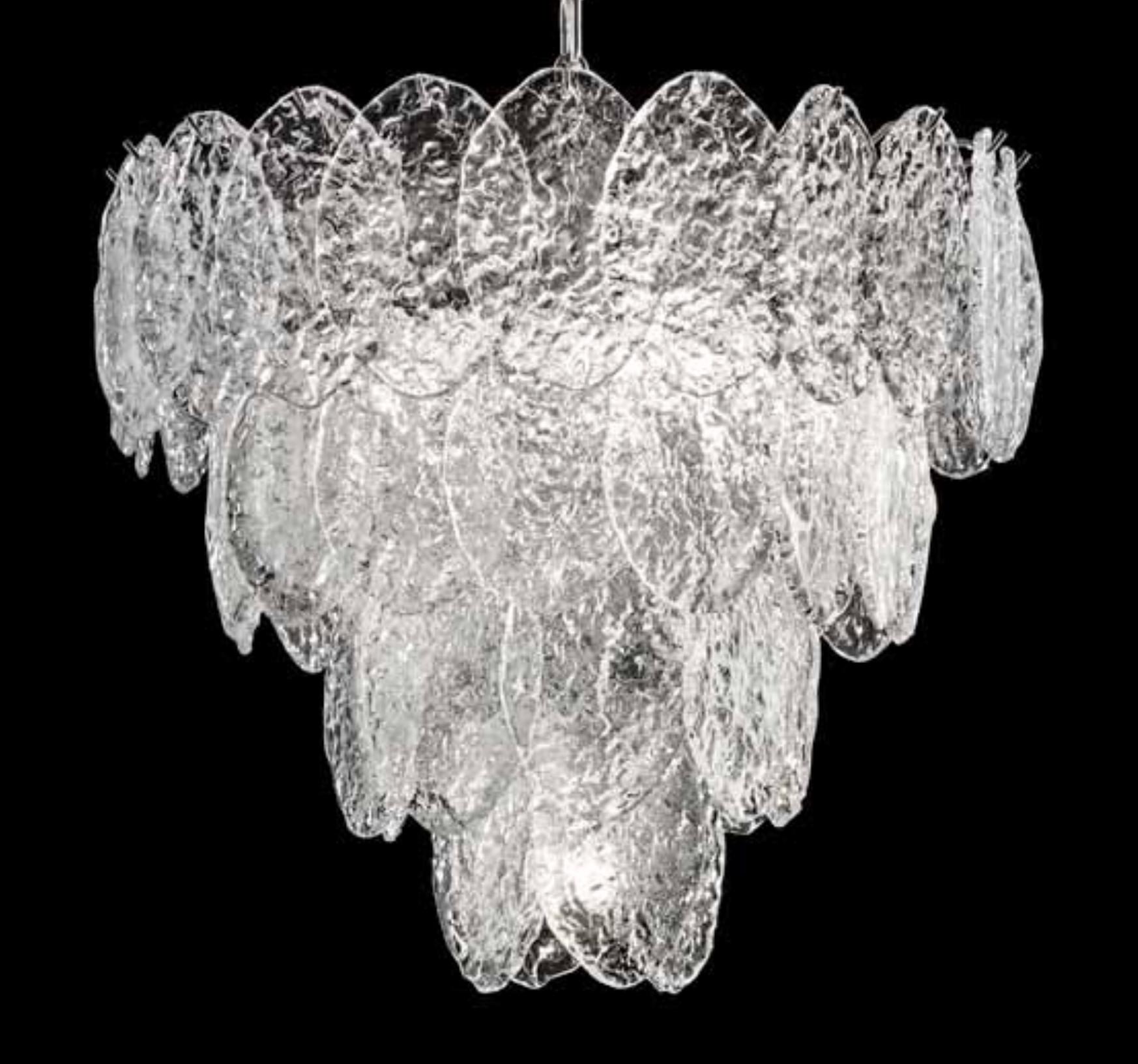 Italian chandelier shown with clear Murano oval discs mounted on chrome finish frame, inspired by Mazzega / Made in Italy
Measures: Diameter 21.5 inches / height 18 inches plus chain and canopy
4 lights / E26 or E27 type / max 60W each
Order only /