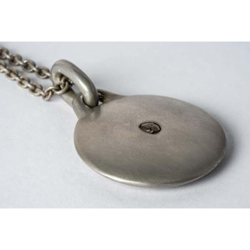 Disk necklace in acid treated sterling silver and a slab of rough diamond. This slab is removed from a larger chunk of diamond, it comes on a 74cm chain. This item is made with a naturally occurring element and will vary from the photograph you see.