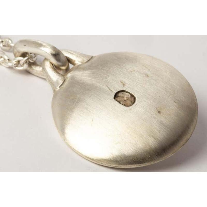 Disk necklace in sterling silver and a slab of rough diamond. This slab is removed from a larger chunk of diamond, it comes on a 74cm chain. This item is made with a naturally occurring element and will vary from the photograph you see. Each piece