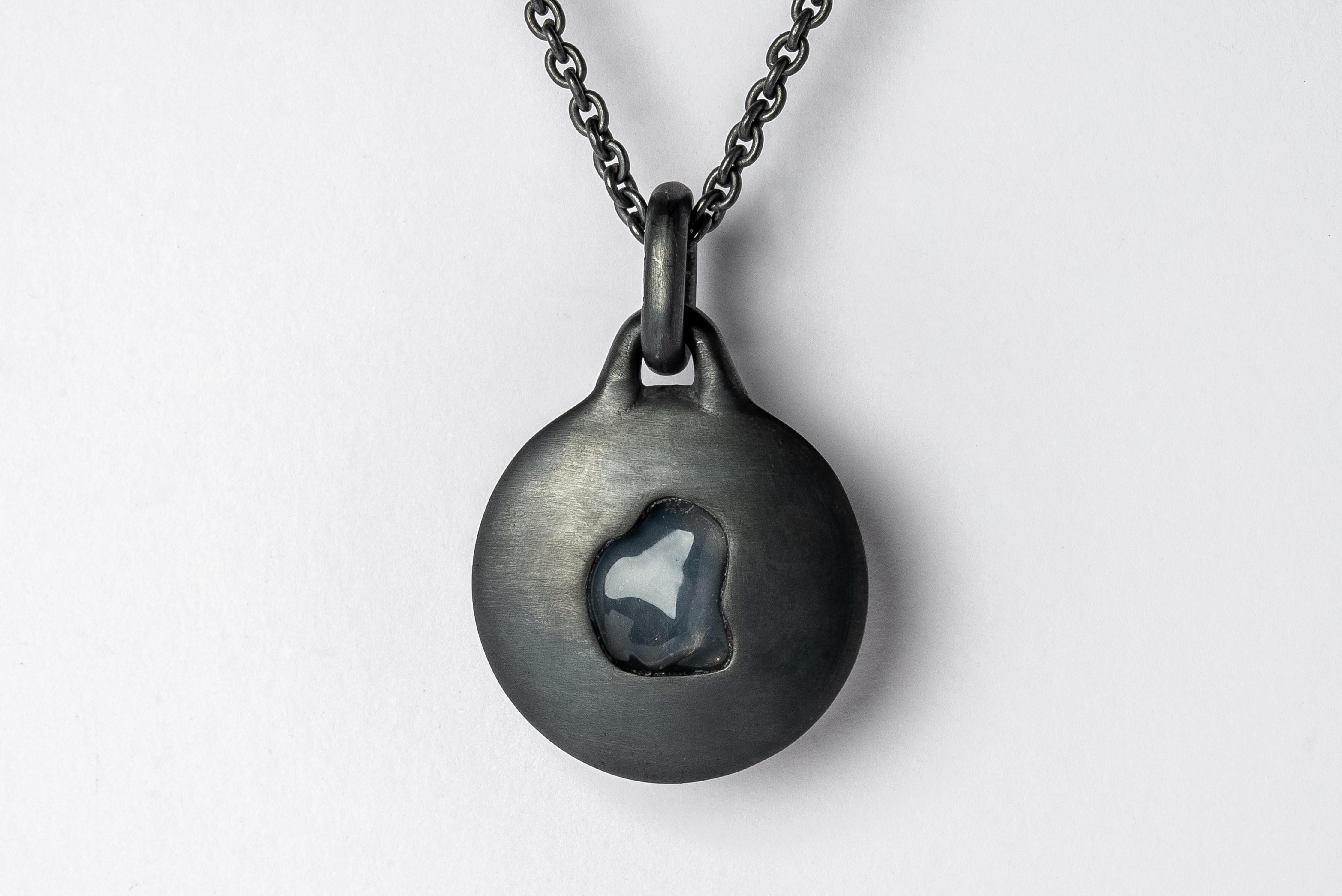Necklace in the disk shape made in oxidized sterling silver and a slab of rough opal. The Disc family is essentially an Amulet, and they centralize focus onto the material. It comes on 74 cm sterling silver chain.