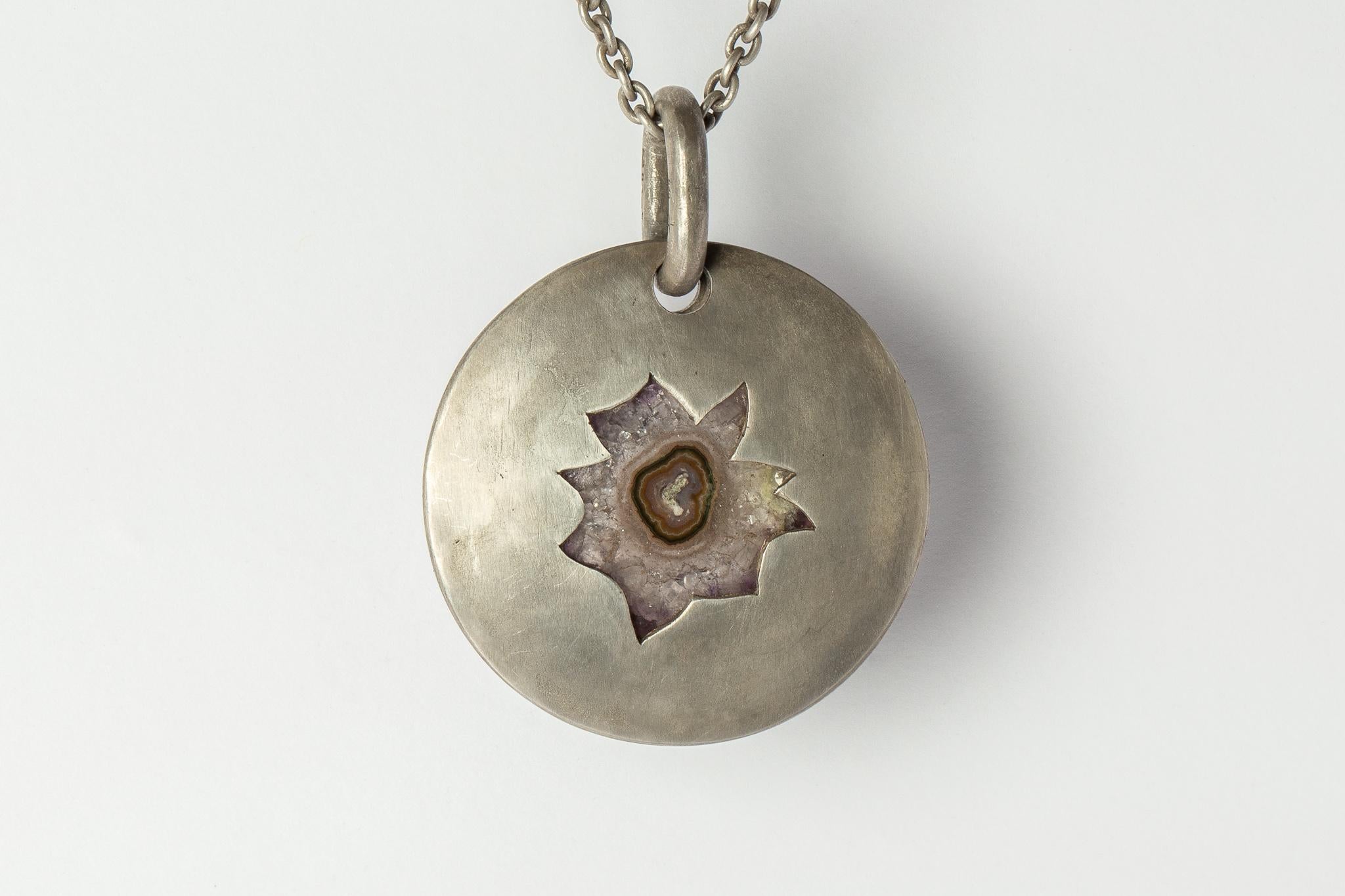Pendant necklace in the disk shape made in dirty sterling and a slab of amethyst cross section stalactite. Sterling silver, dipped in acid to create a subdued surface. Results will never be identical, and this nuance / variation should be seen as a