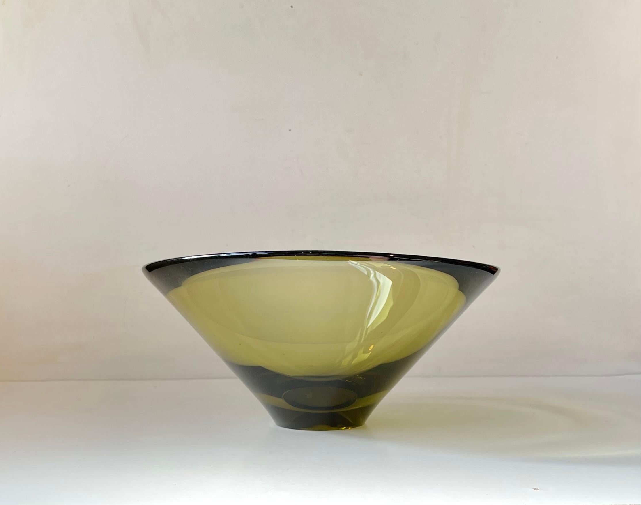 Titled 'Disko' this ultra rare hand-blown olive green glass bowl by Per Lütken was made in 1961. The name Disko has nothing to do with disco. In fact the name was inspired by the reflections of light Lütken experienced visiting Diskobugten/ Disko