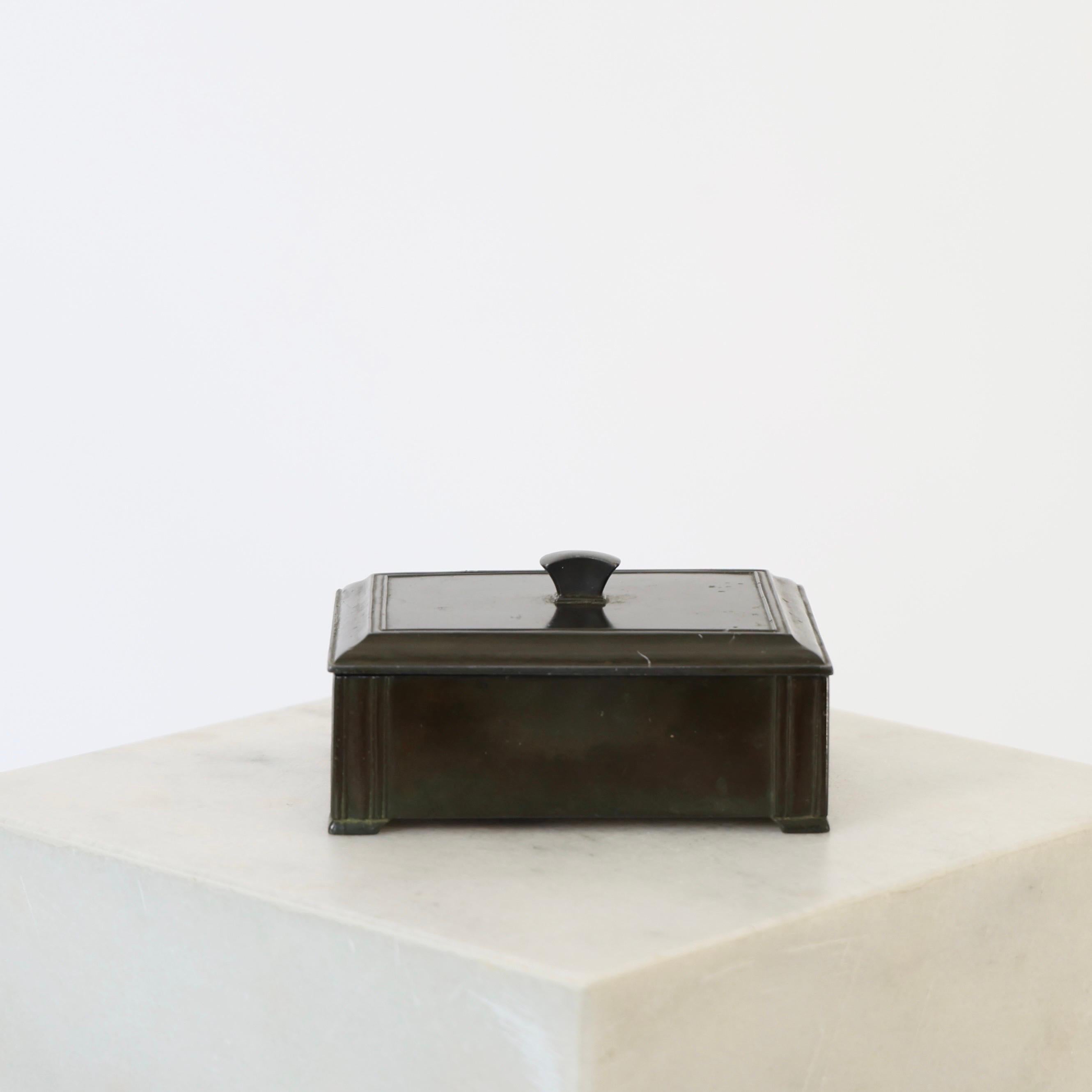 Elegant Diskometal Casket made by Just Andersen in the early 1930s.

* Lidded diskometal casket / jewelry box with inner wood box. 
* Designer: Just Andersen
* Style: D1604
* Year: 1933
* Condition: Good vintage condition. Makers engraving intact.