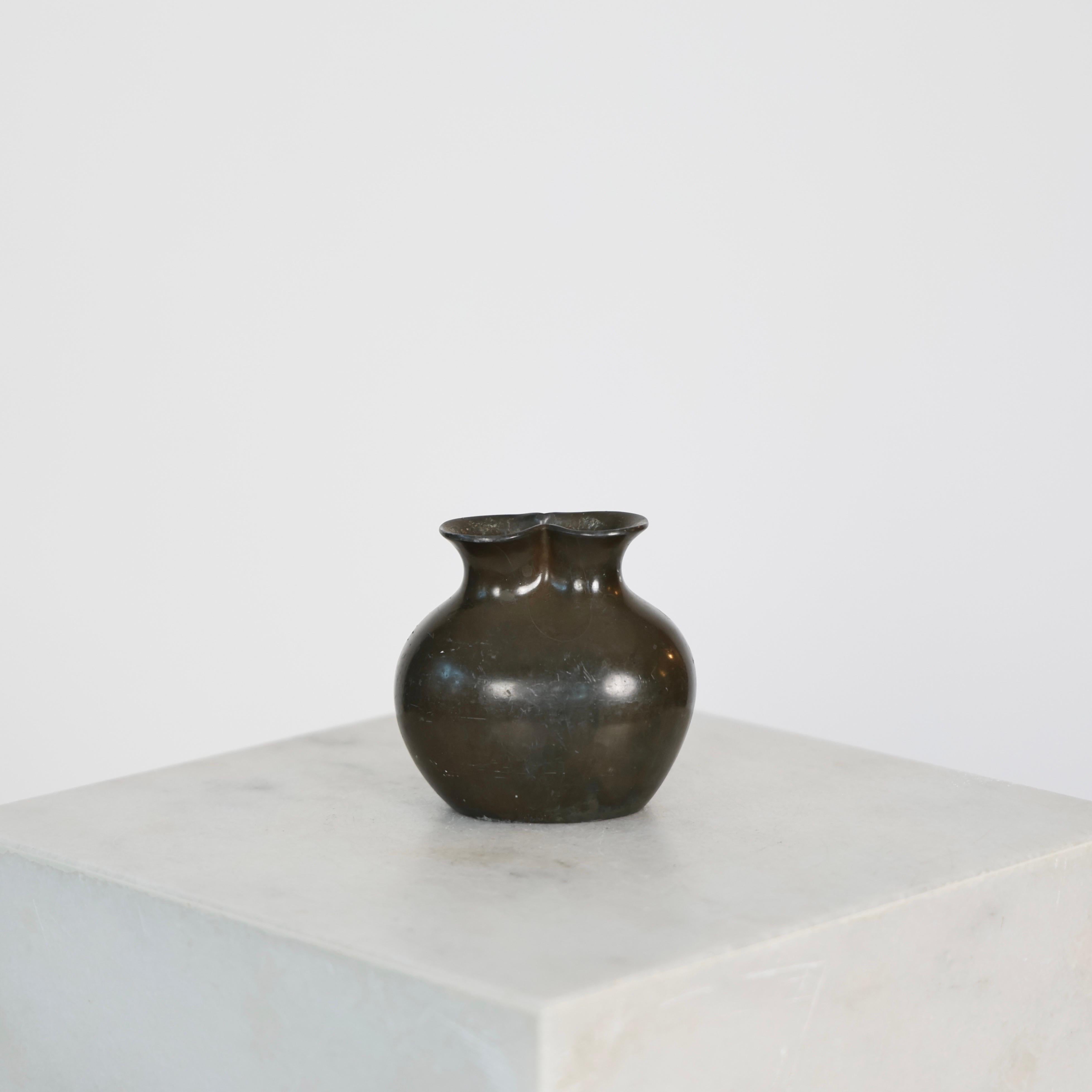 Little Diskometal Vase made by Just Andersen in the 1920s.  

* Diskometal vases with opening shaped as figure-eight (from top down)
* Designer: Just Andersen
* Model: D120 
* Year: 1926-1929
* Condition: Fair vintage condition. Makers engraving