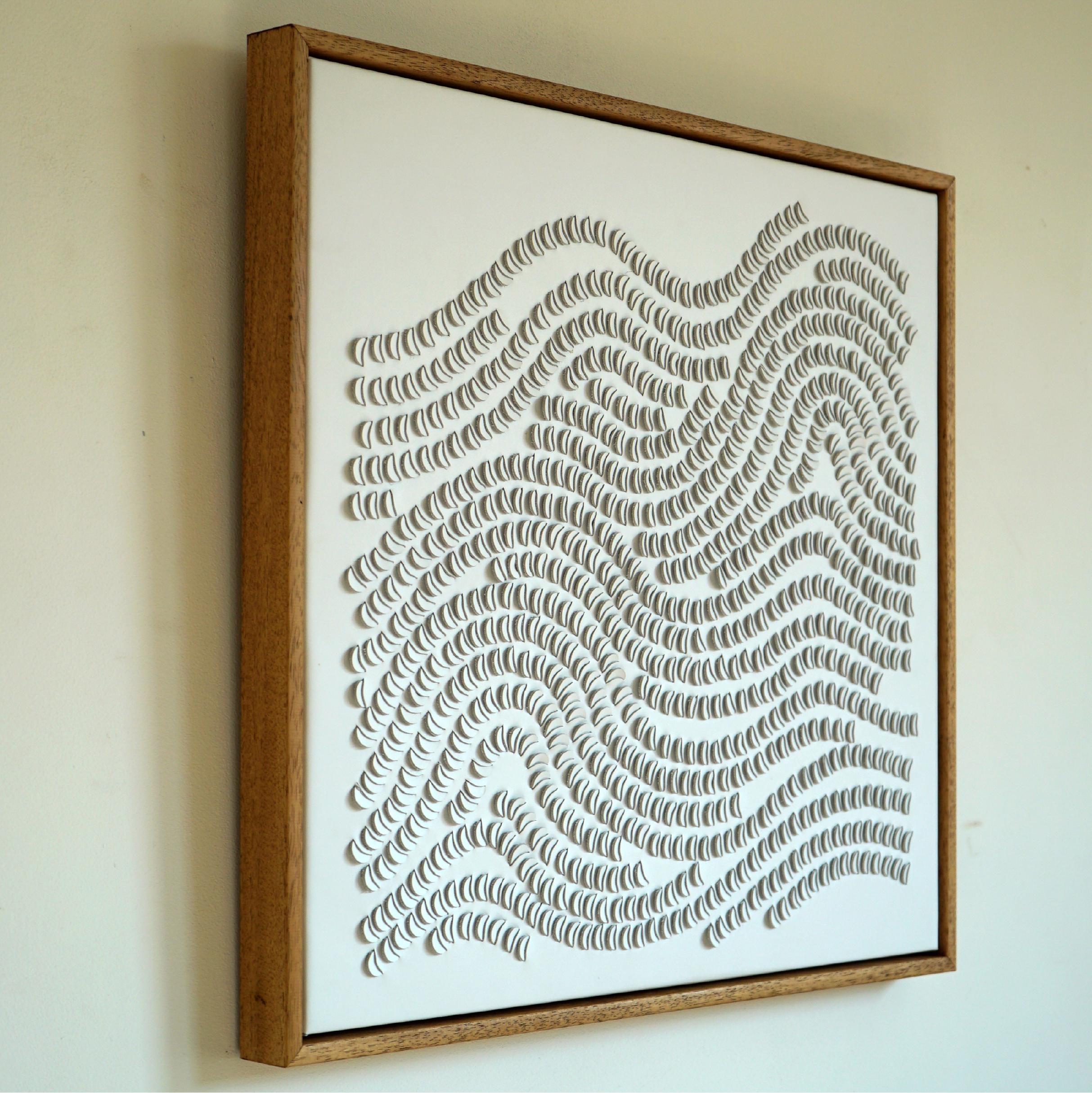 Disks:

A piece of 3D sculptural wall art designed and made from two layers of white leather, woven together by Louise Heighes.
Measurements are 21 x 21 inches or 54 x 54 cm.

One, single curved element has been repeated over and over again giving