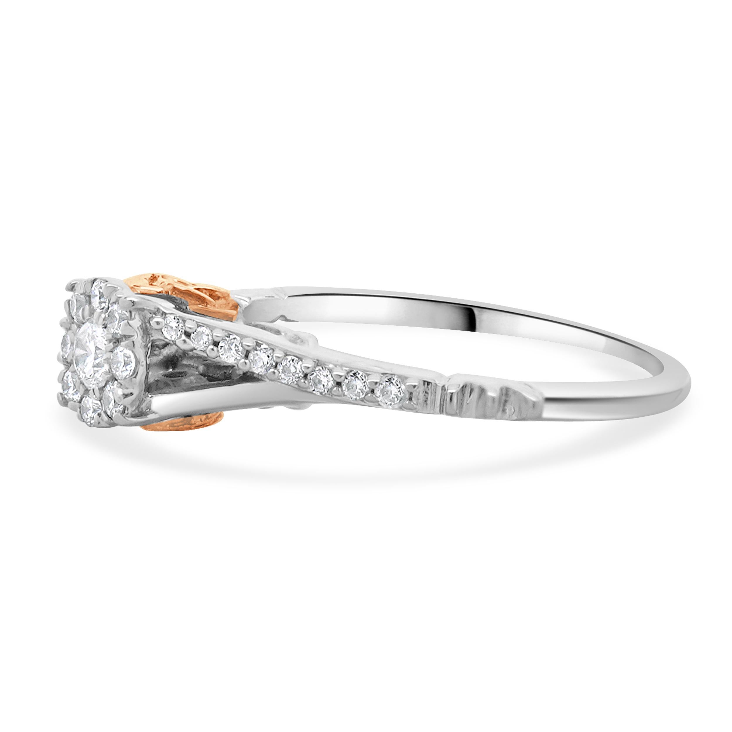 Designer: Disney
Material: 10K white & rose gold
Diamond:  25 round brilliant cut = 0.31cttw
Color: H
Clarity: SI2
Dimensions: ring top measures 5mm wide
Ring Size: 5 (complimentary sizing available)
Weight: 1.83 grams
