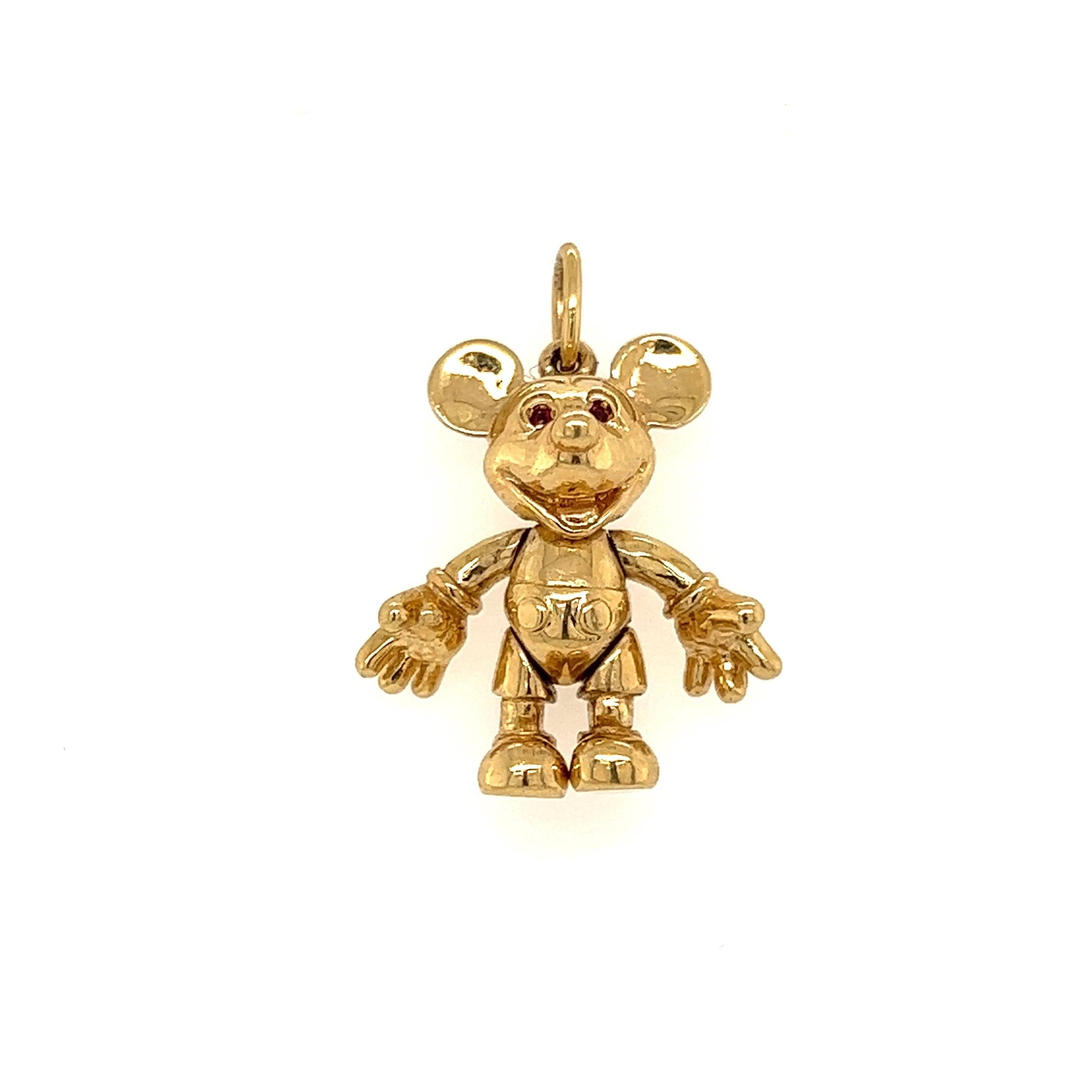Delightful and Finely Detailed Walt Disney Articulated Mickey Mouse Charm Pendant. Hand crafted Ruby eyes. Hand crafted in 14K Yellow Gold. Measuring approx. 1.10” l x 0.80