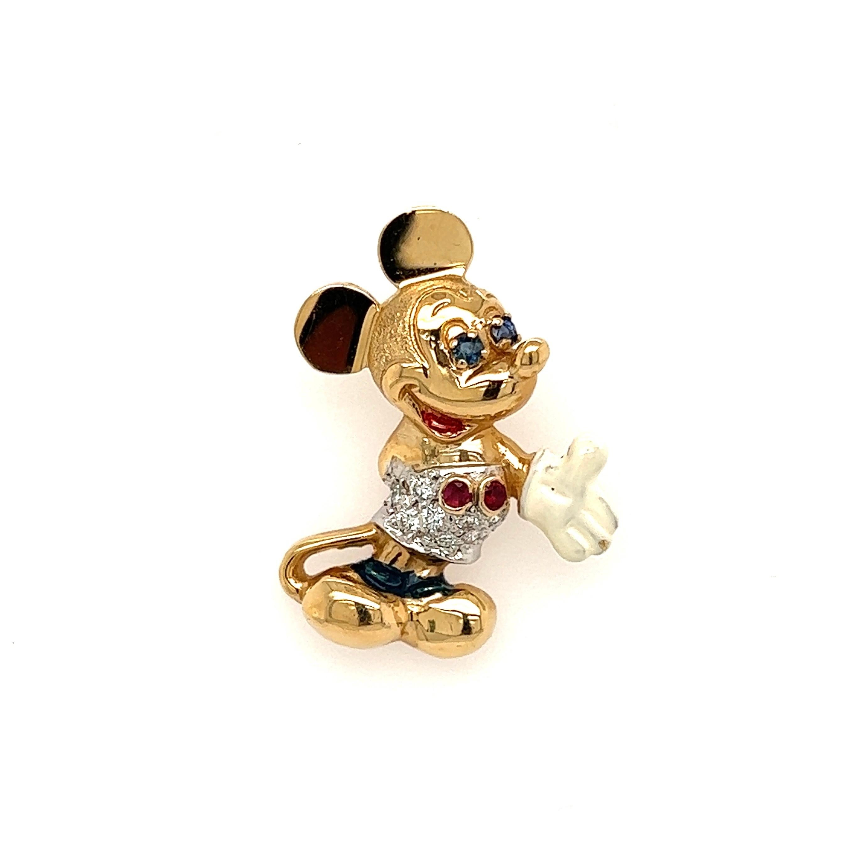 Delightful and Finely Detailed Walt Disney Mickey Mouse Enamel Gold Charm Pendant. Hand crafted in 14K Yellow Gold. Hand set with Rubies, Sapphires and Diamonds. Measuring approx. 1.10” l x 0.80