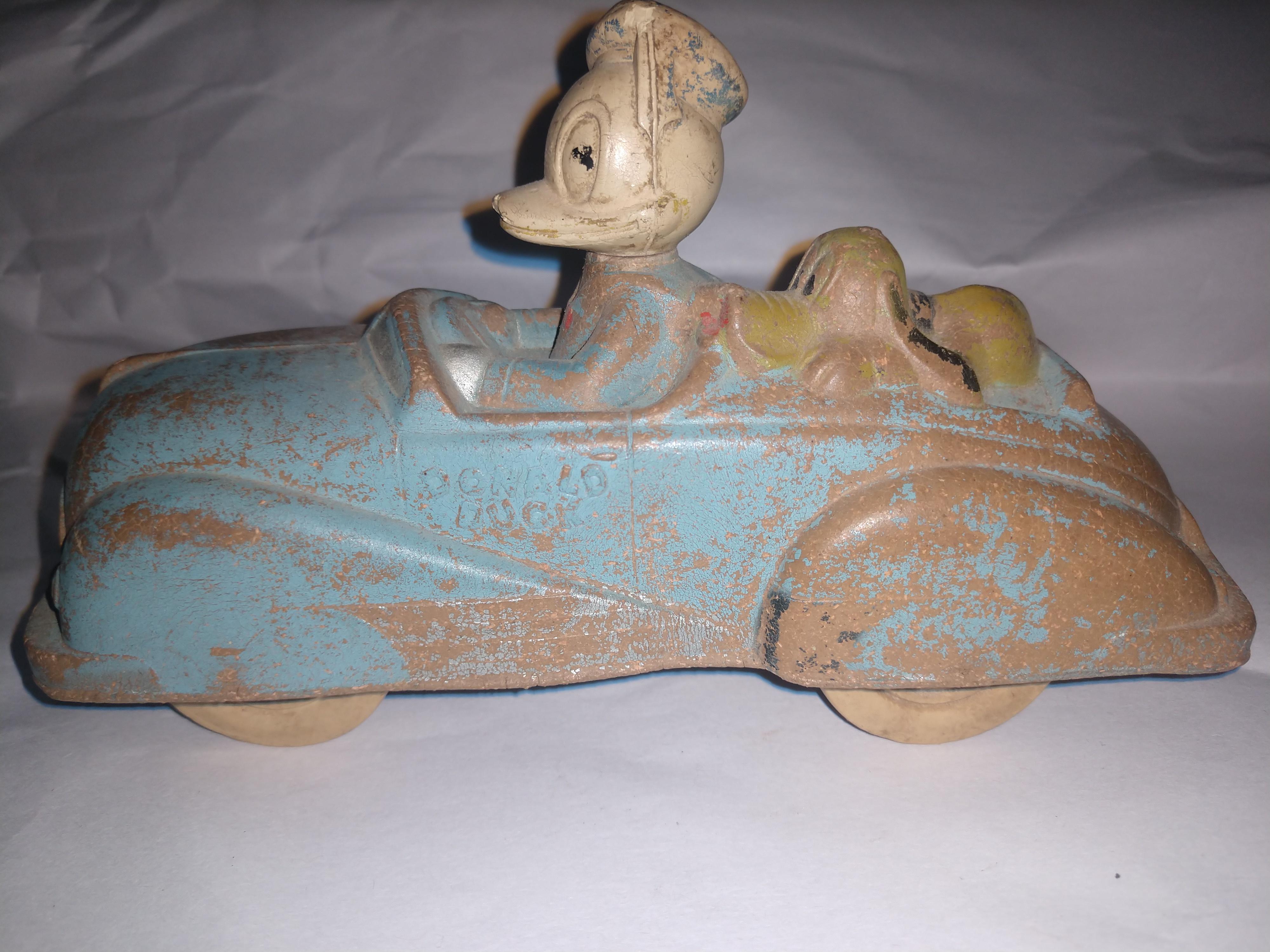 A blast from the past, Donald Duck and Pluto in the sun rubber convertible. Totally intact with the color faded.