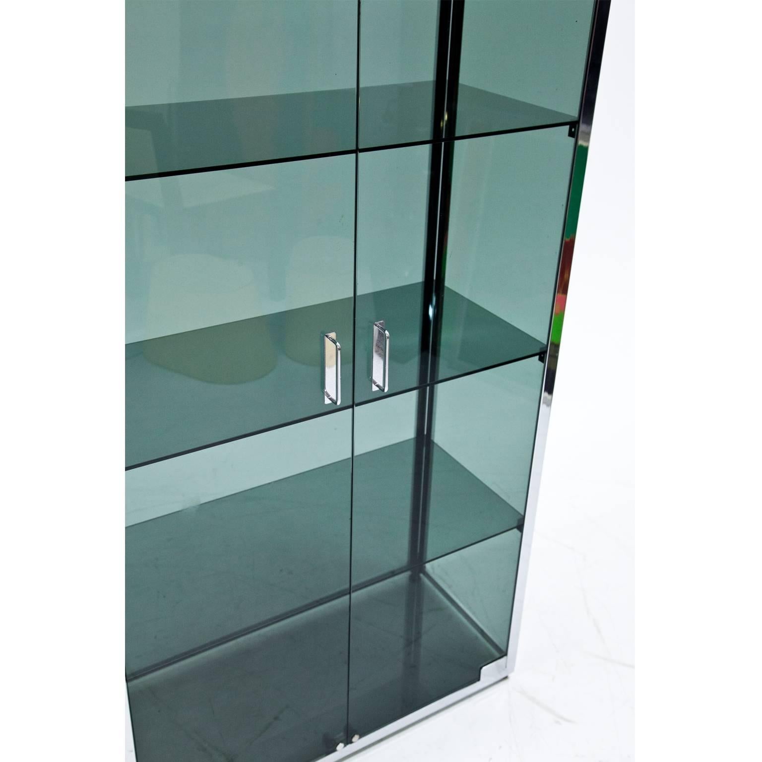 Two-doored display case with an all-round glazing and chromed framing. The glass panes are slightly tinted green.