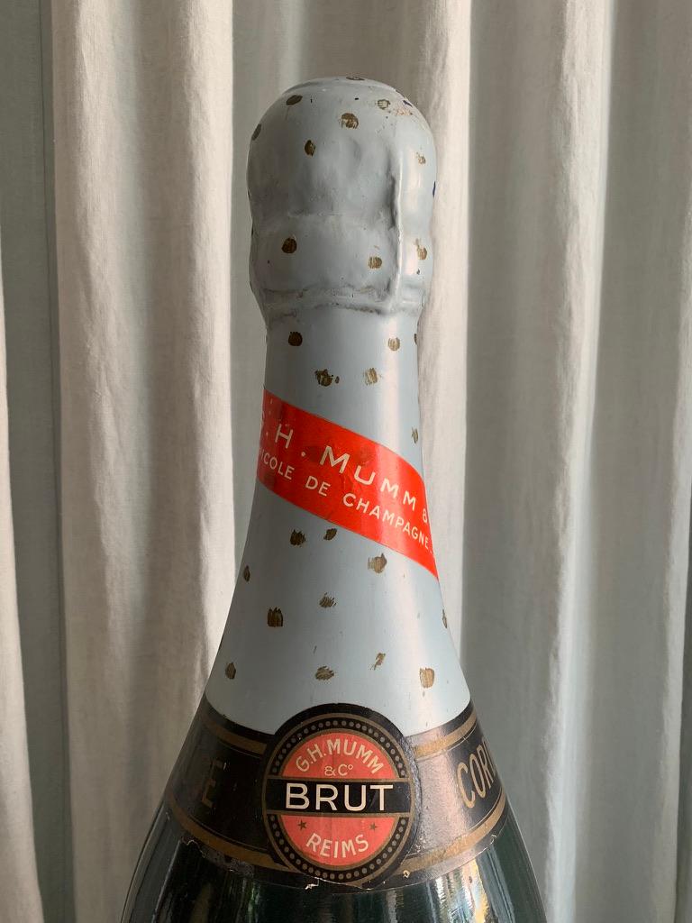 Large French vintage fiber glass display model of a G.H. Mumm Cordon Rouge champagne bottle for promoting the brand in a wine shop. Super decorative item for the bar or wine cellar.