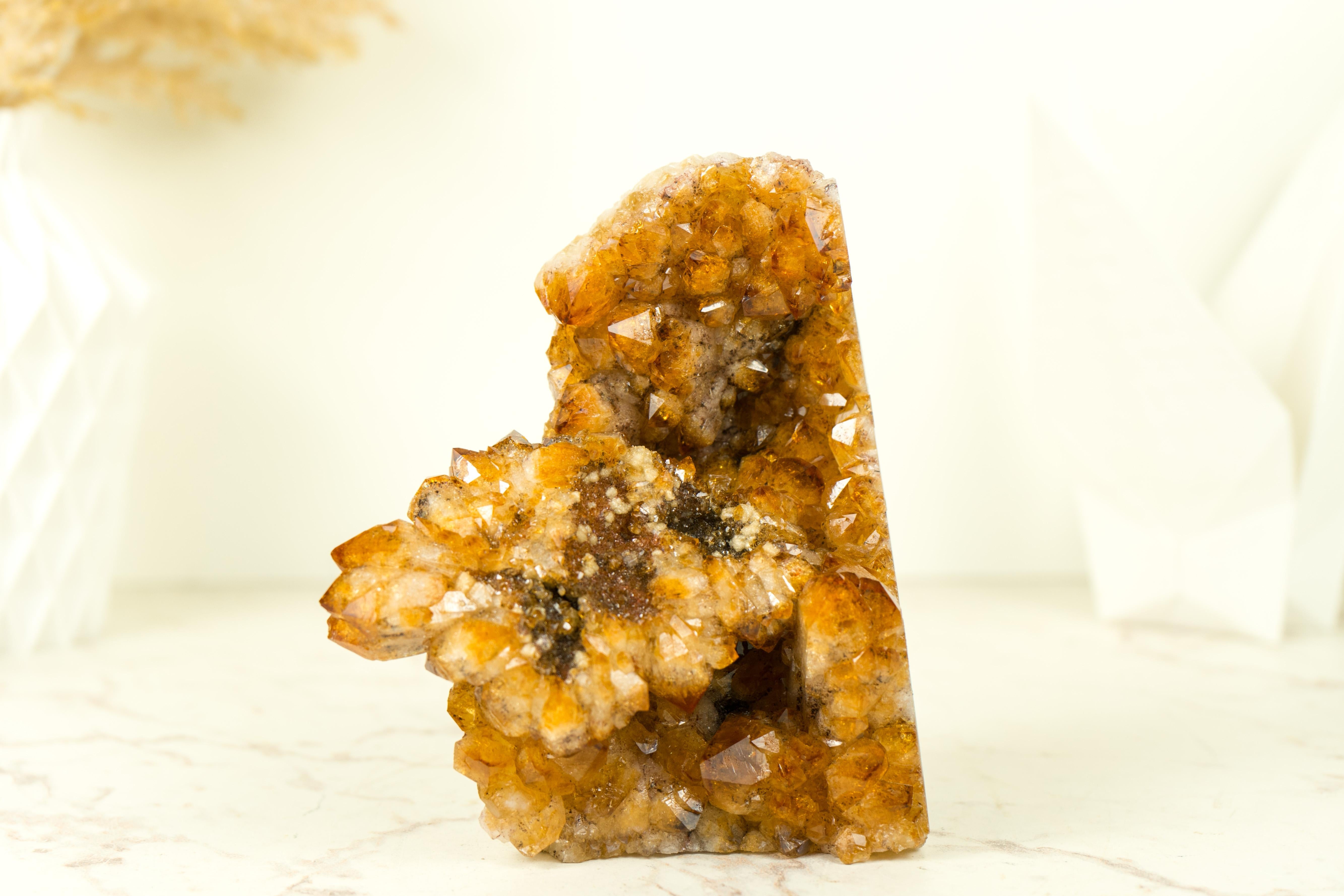 A Rare Citrine Cluster that boasts world-class color tones, beautiful aesthetics, and a unique Citrine Flower that clusters on its side. his extraordinary crystal is guaranteed to be a stunning addition to your crystal collection, office table, or