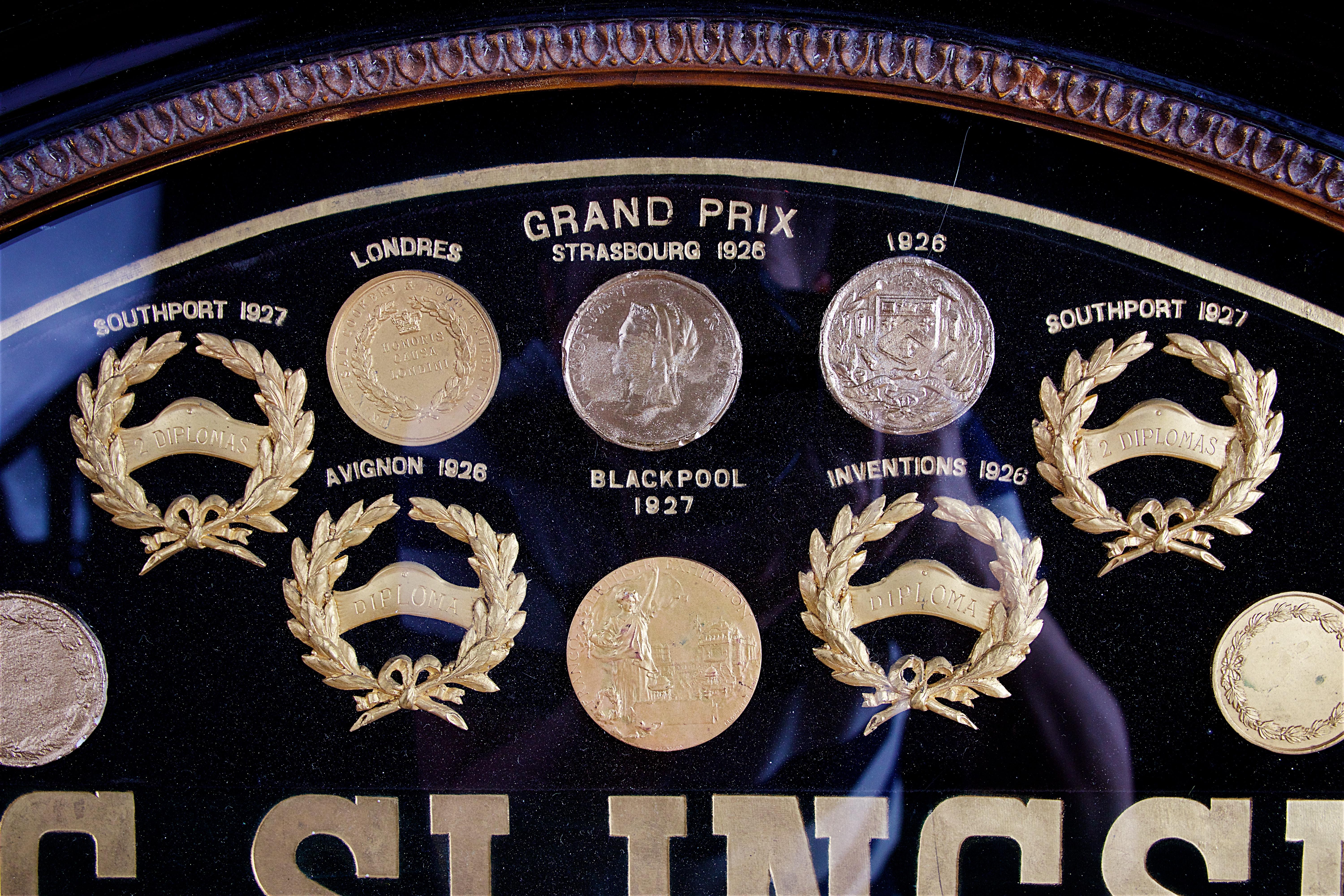 Ebonized Display of Medals from H.C. Slingsby Truck Company, Set in Large Oval Frame For Sale