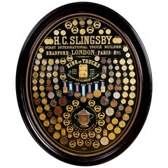 Display of Medals from H.C. Slingsby Truck Company, Set in Large Oval Frame