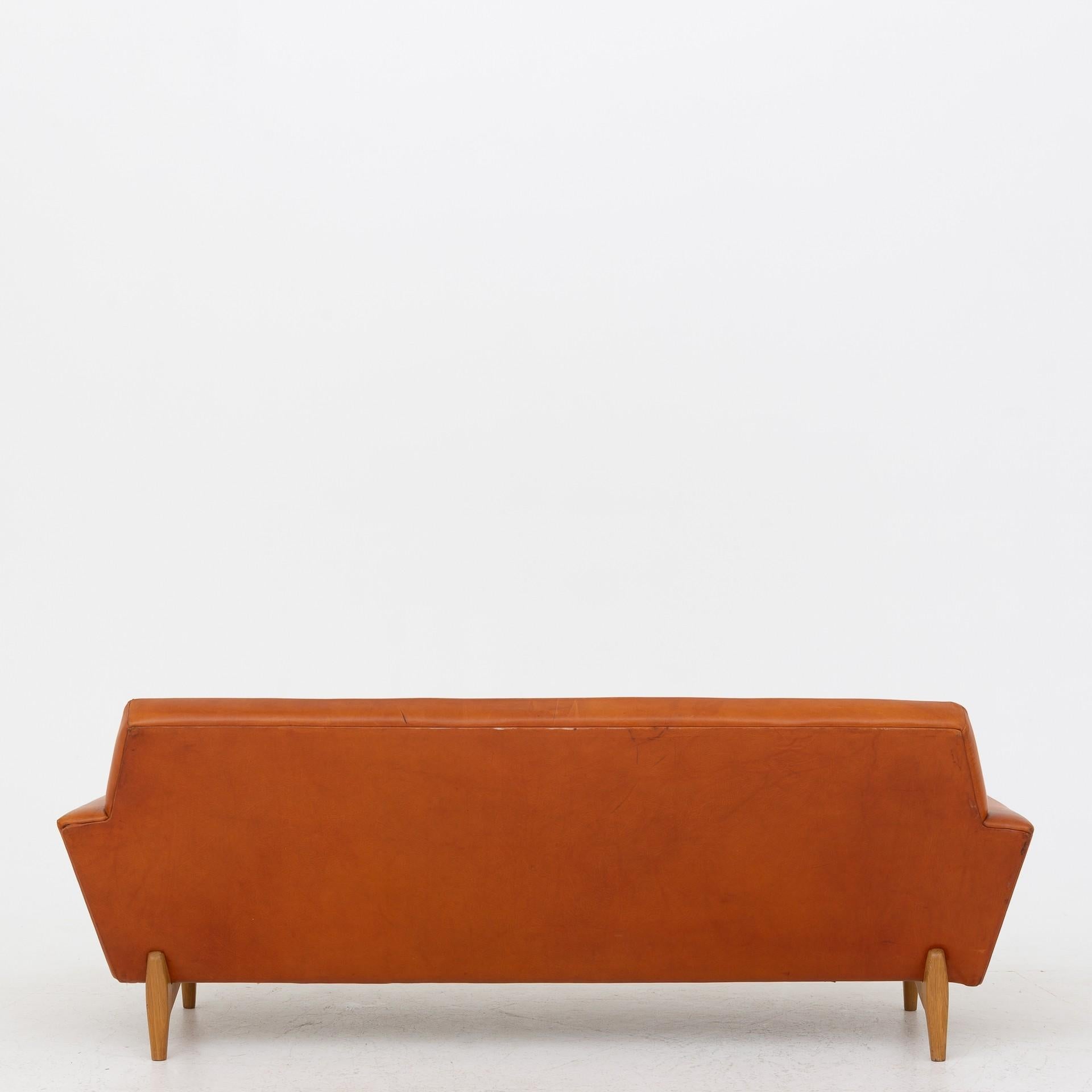 'Disponenten' three-seat sofa in patinated brown natural leather with legs of oak. Maker Oluf Persson OPE.